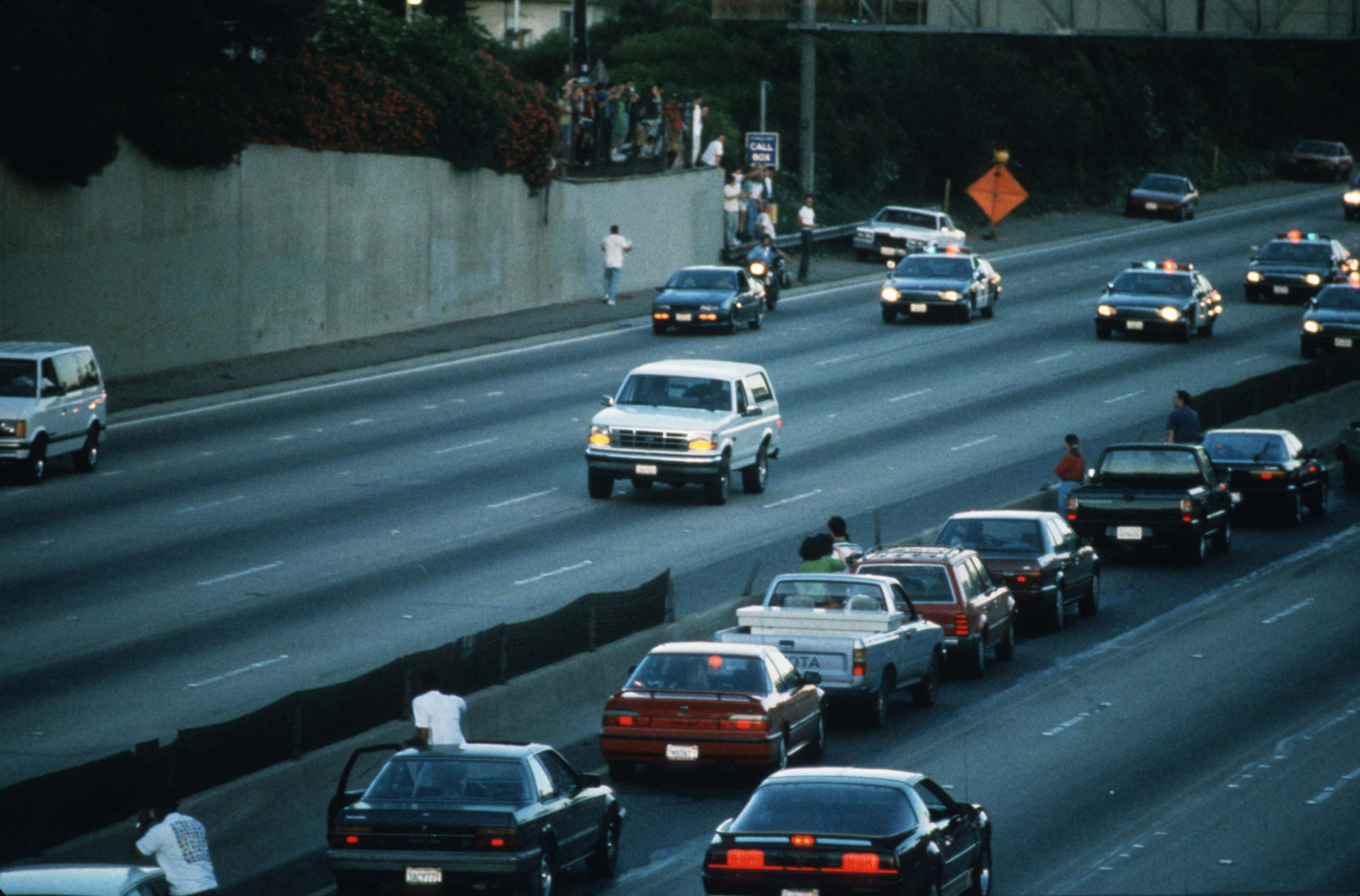 Motorists pull over to watch police pursue O.J. Simpson in a Ford Bronco on June 17, 1994, in Los Angeles, California.