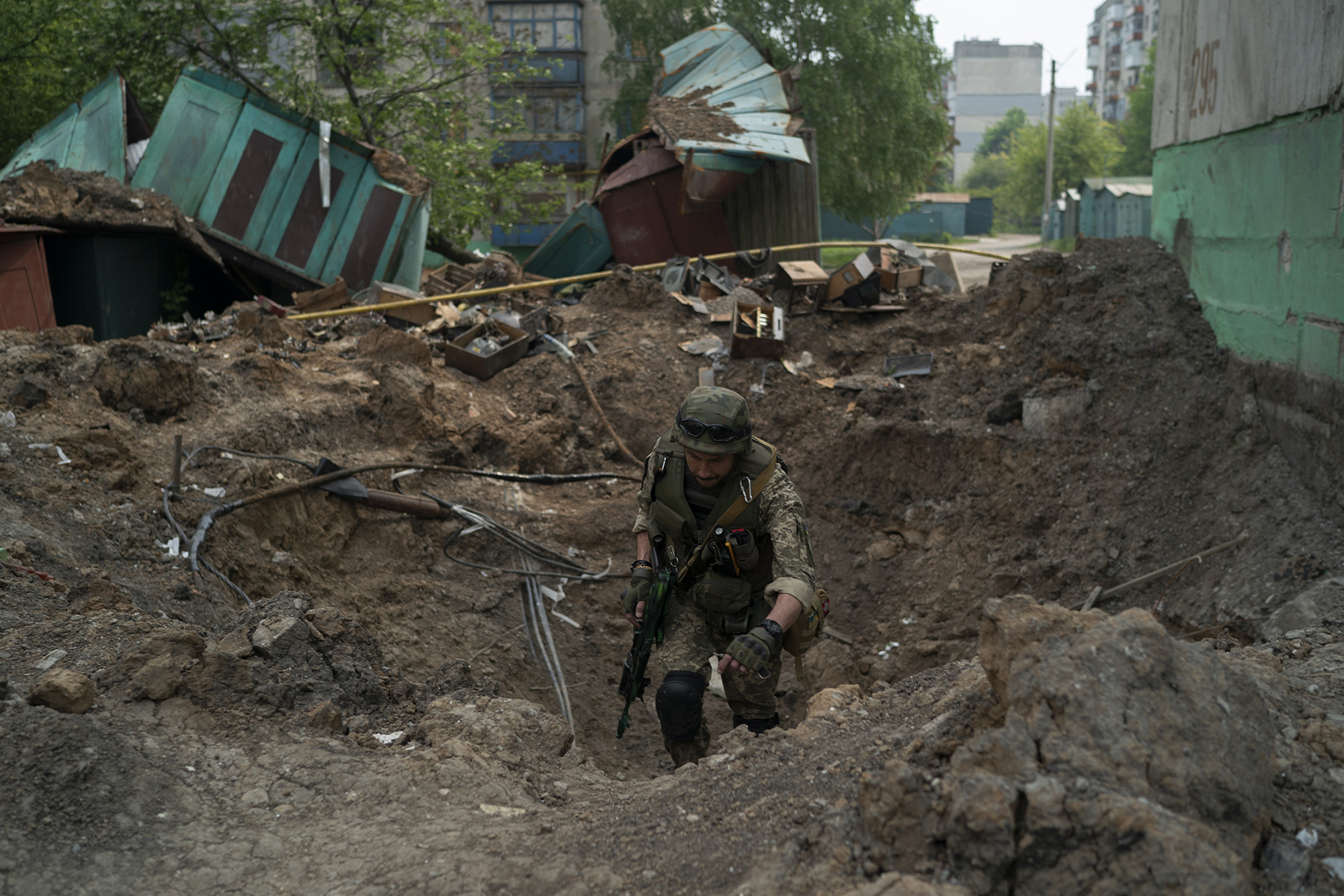 A special task force policeman inspects a site after an airstrike by Russian forces in Lysychansk, Ukraine on Friday, May 13.