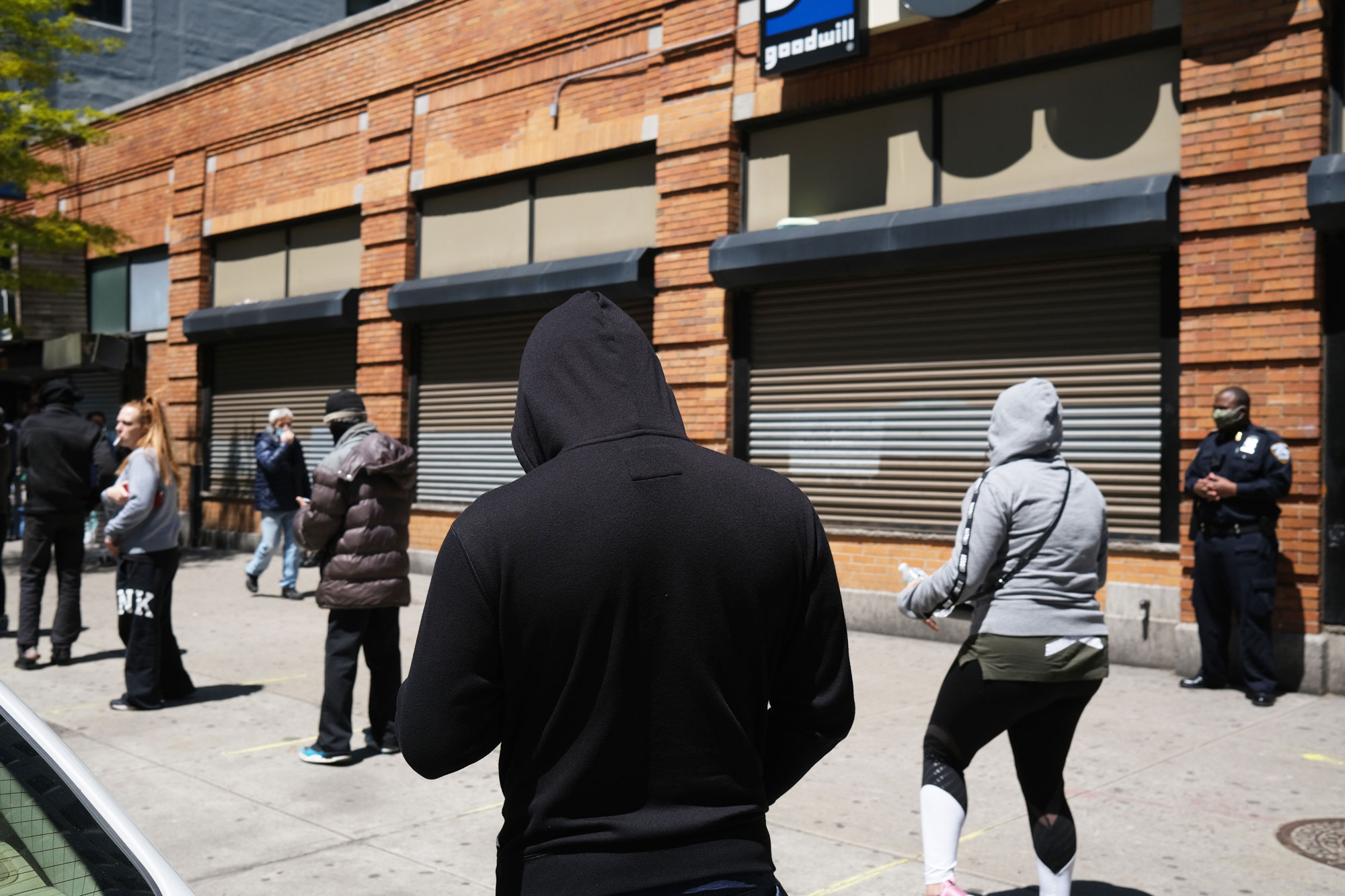 Hundreds of people wait in line for hours at a downtown Brooklyn office for their EBT Food Stamp cards on May 12 in New York City. 