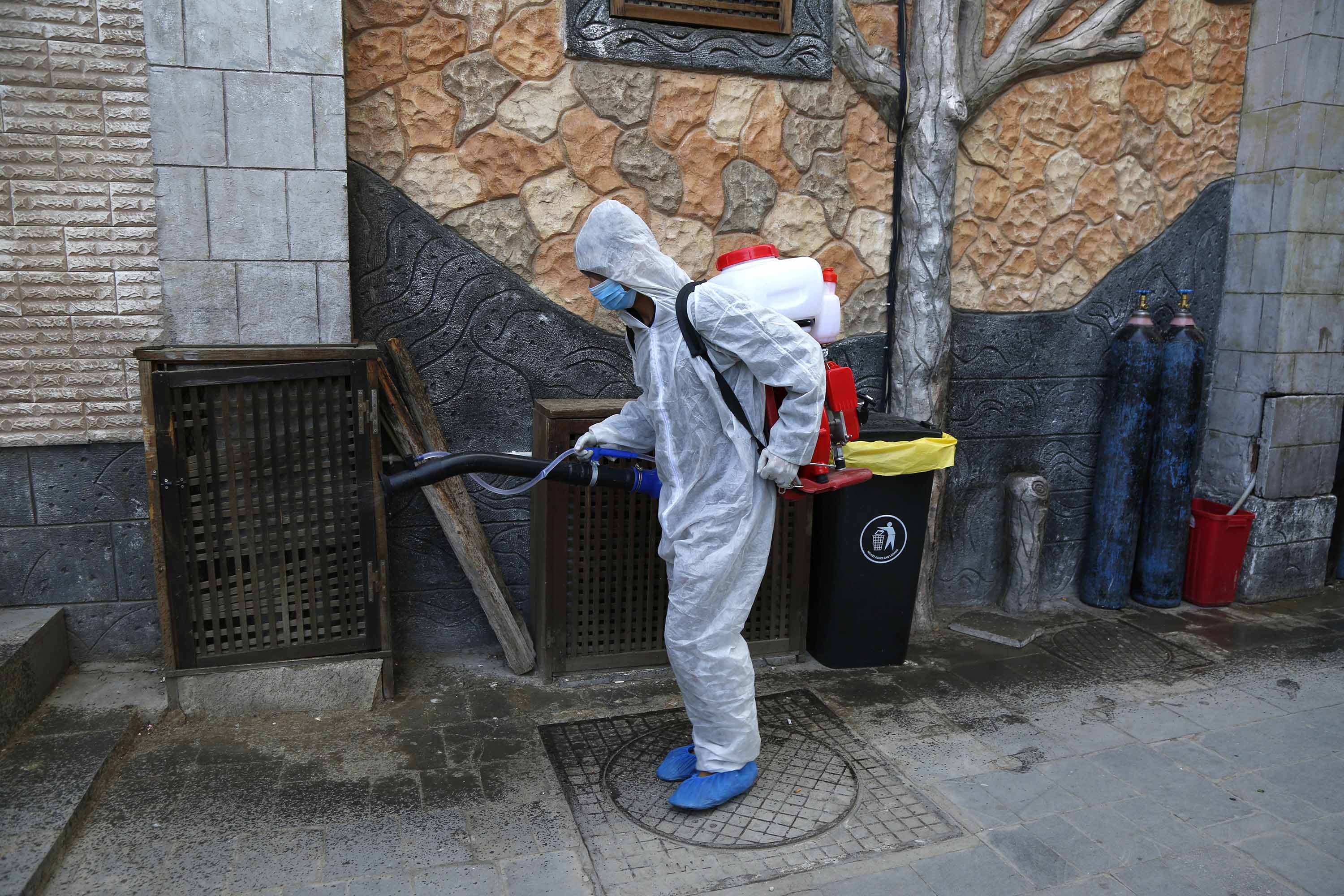 A member of a medical team sprays disinfectant in Sanaa, Yemen, on April 6.