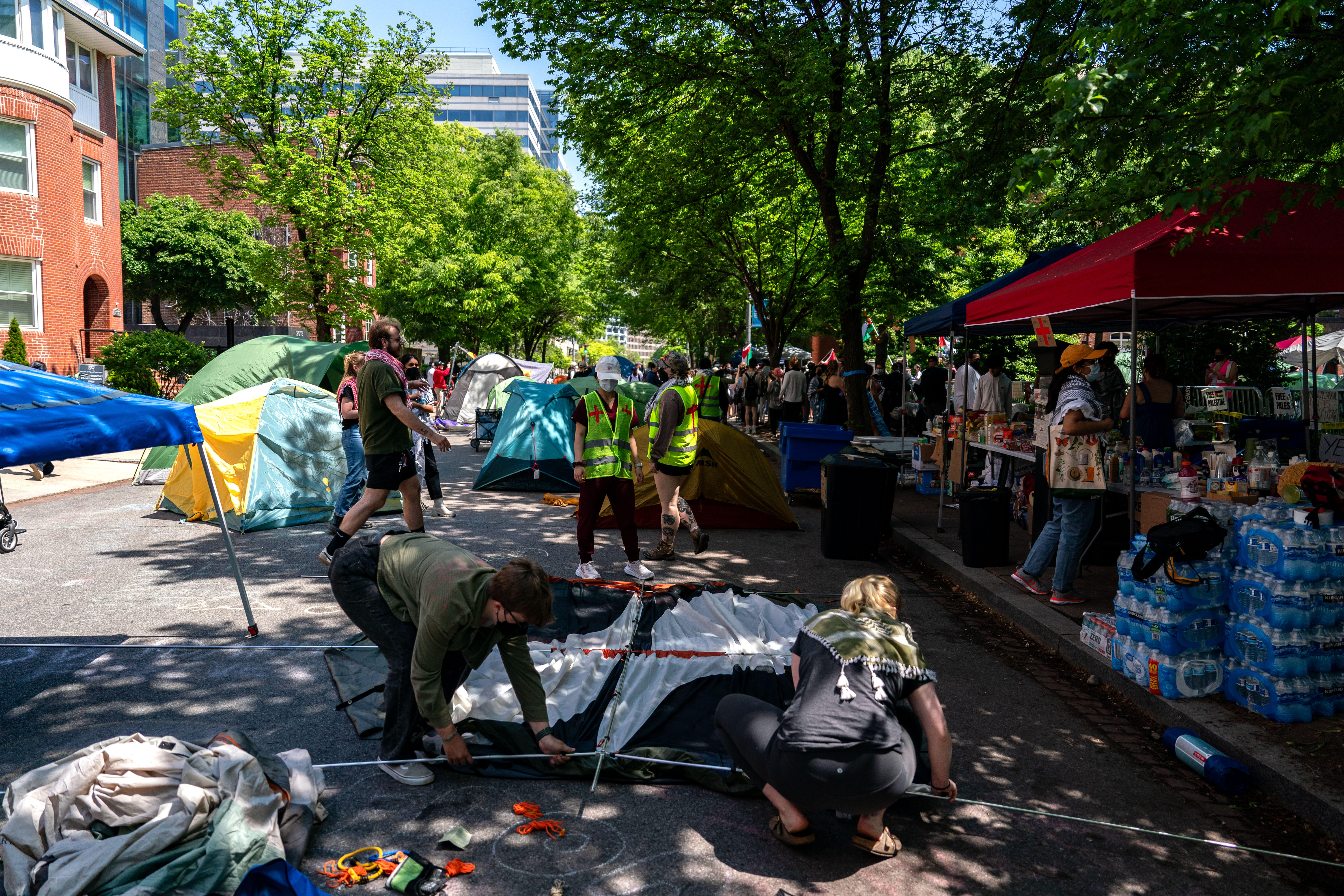 People set up more tents along H street as they protest at George Washington University in Washington, DC, on April 28.
