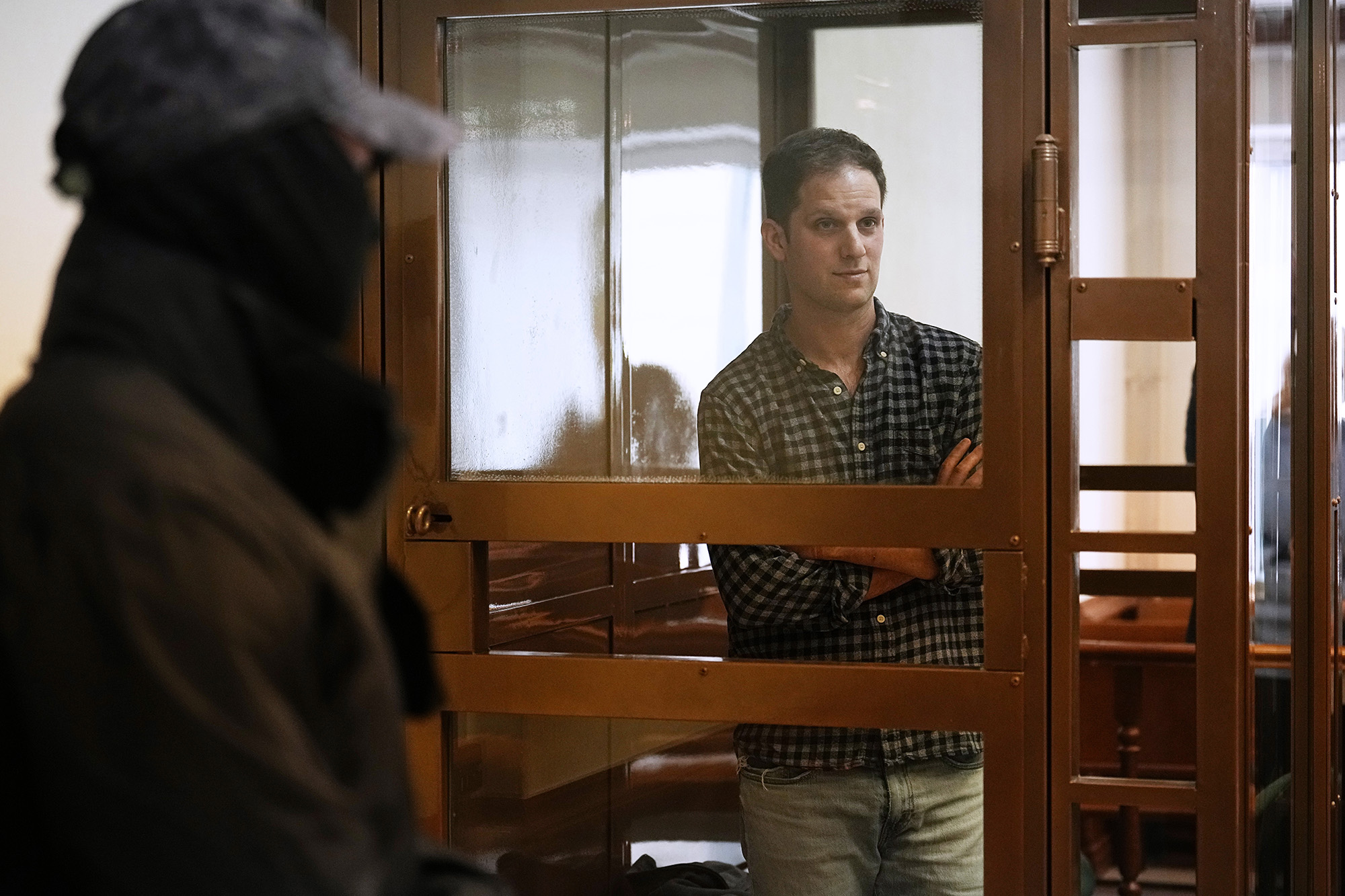 Wall Street Journal reporter Evan Gershkovich stands in a glass cage in a courtroom at the Moscow City Court, in Moscow, Russia, on April 18.