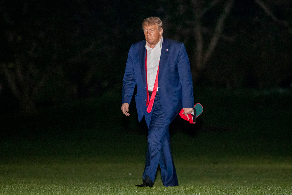 President Donald Trump walks on the South Lawn of the White House in Washington early on Sunday, June 21, after stepping off Marine One as he returns from a campaign rally in Tulsa, Oklahoma.
