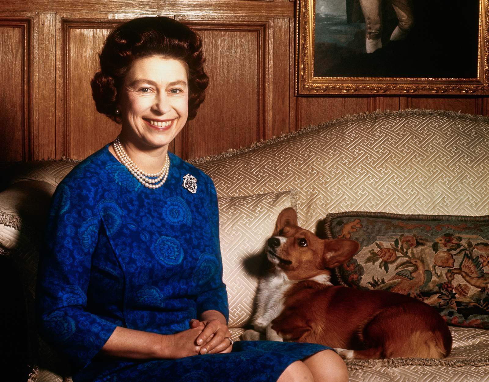 Queen Elizabeth poses for a picture with one of her Corgi's at Sandringham House, Norfolk on February 4, 1970.