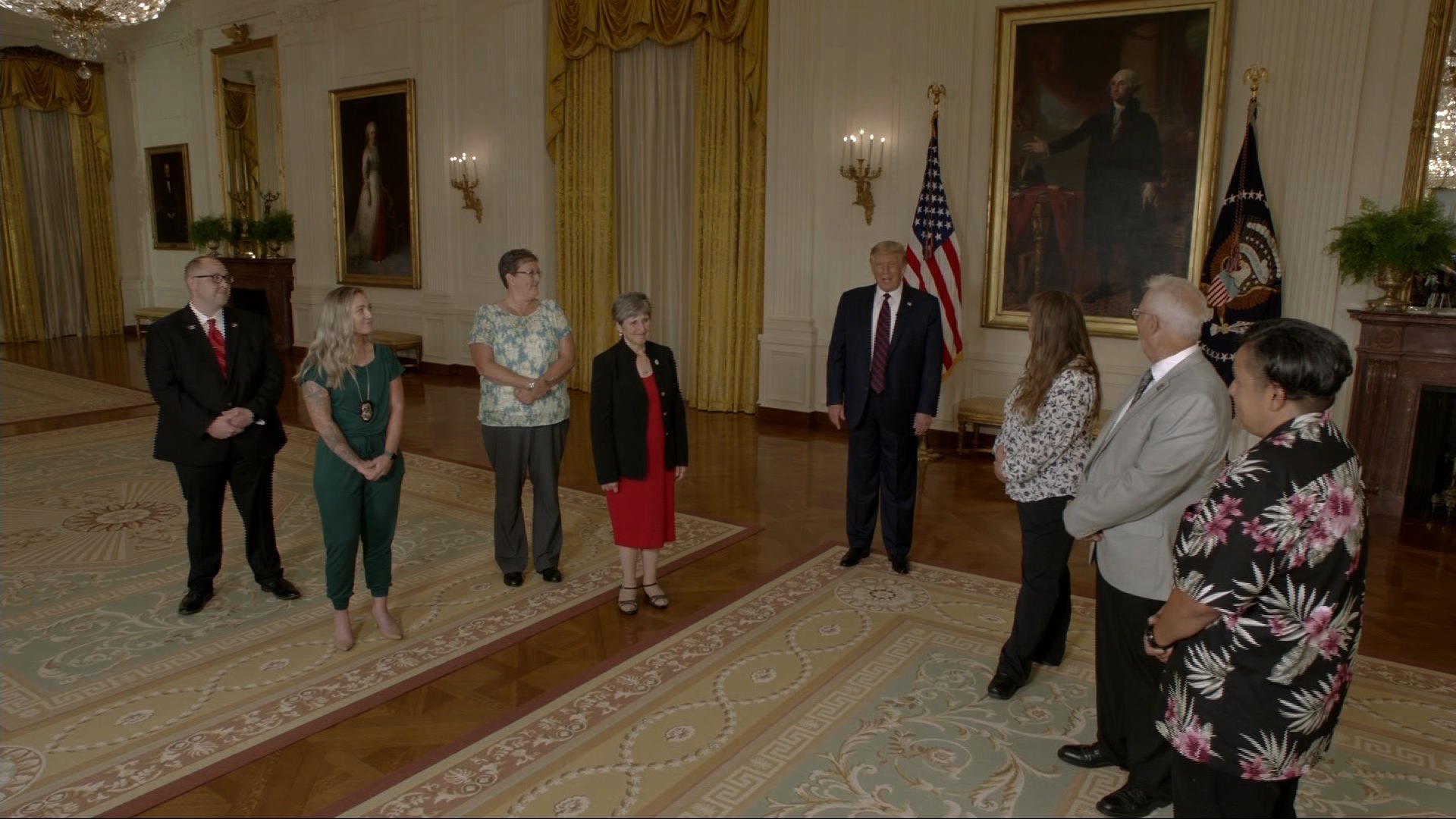 President Trump speaks to frontline workers in the White House in Washington.