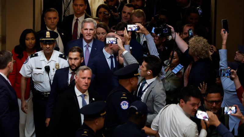 Former Speaker of the House Kevin McCarthy is surrounded by staff, security and journalists as he walks through Statuary Hall after he was ousted at the Capitol on October 3, 2023, in Washington, DC.