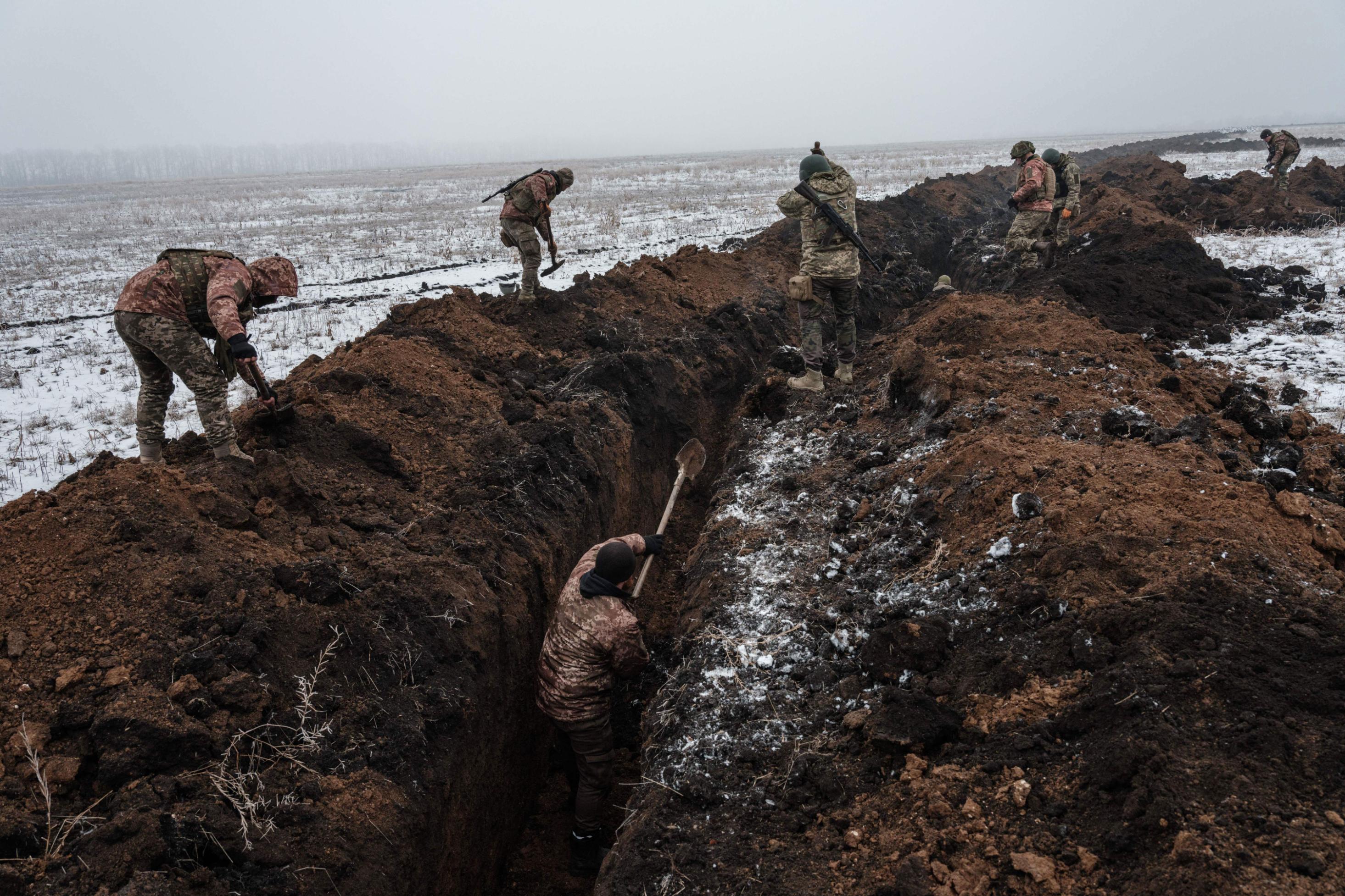 Ukrainian servicemen make a trench near Bakhmut on February 1, 2023, amid the Russian invasion of Ukraine. (Photo by YASUYOSHI CHIBA / AFP) (Photo by YASUYOSHI CHIBA/AFP via Getty Images)