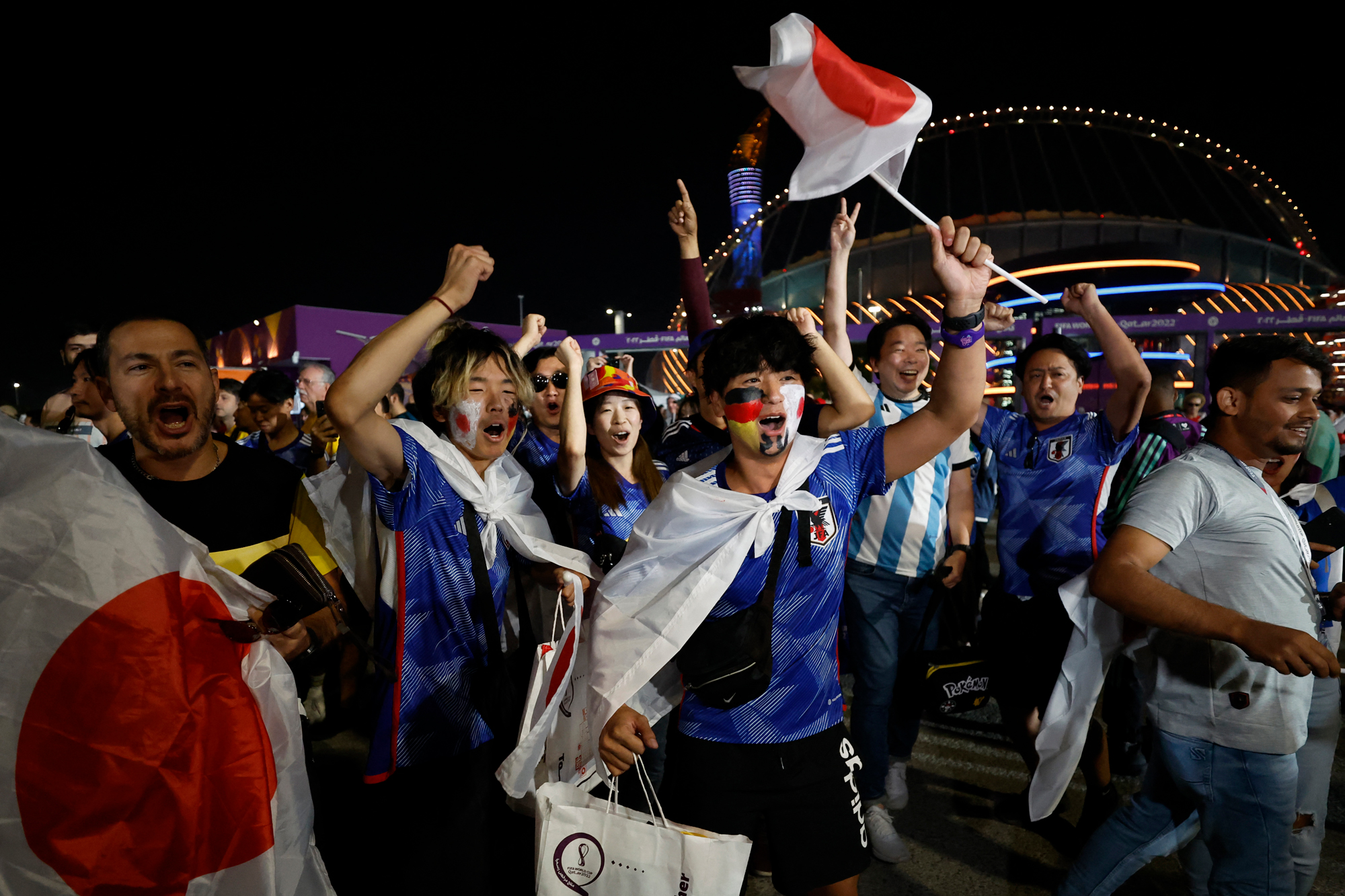 Japan fans celebrate outside the Khalifa International Stadium after the match in Doha, Qatar on Wednesday.