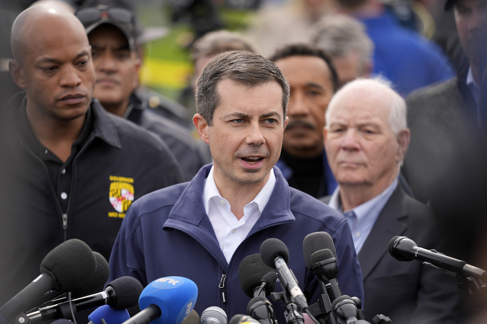Transportation Secretary Pete Buttigieg, center, speaks during a news conference near the scene where a container ship collided with a support on the Francis Scott Key Bridge, Baltimore, on March 26.