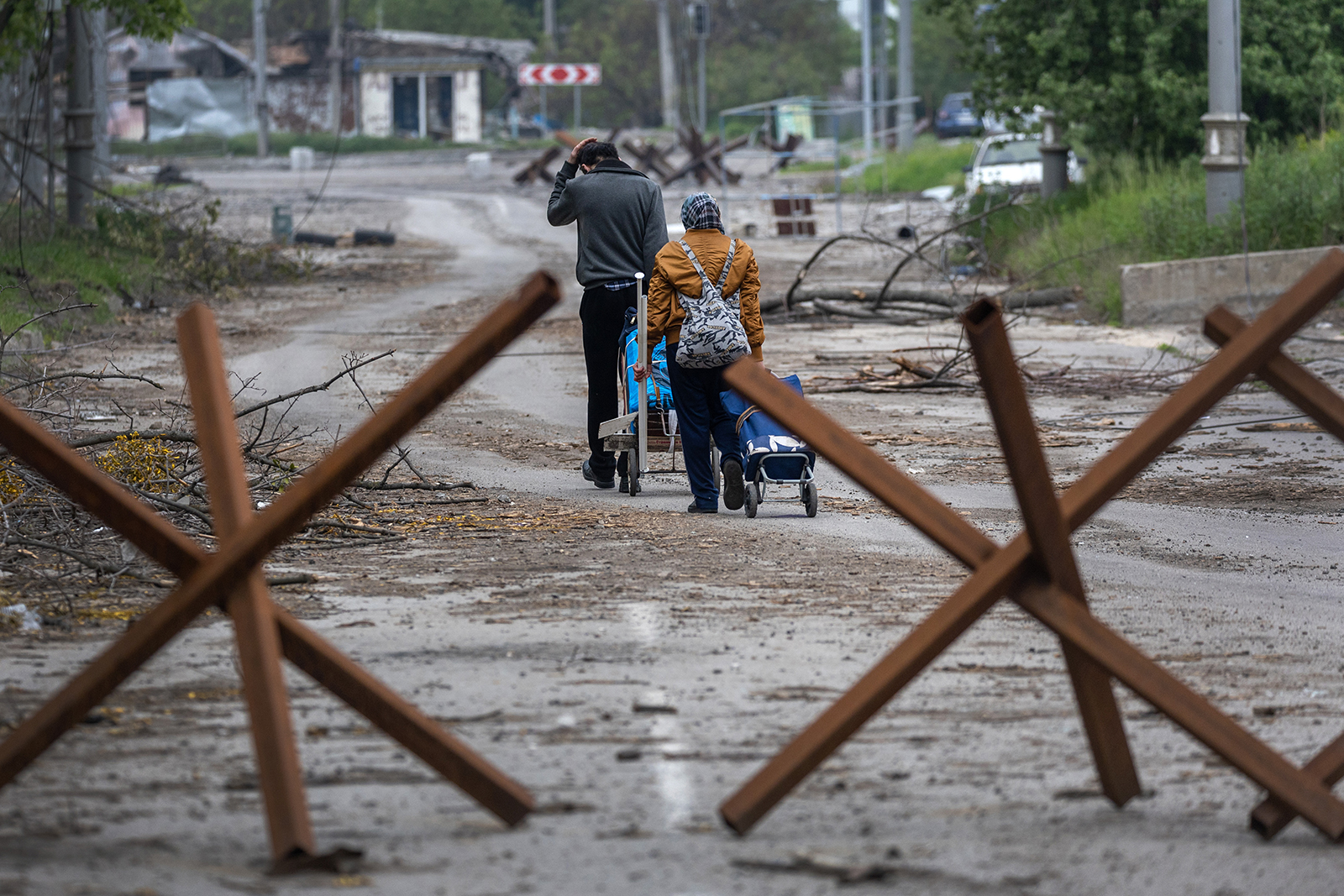Local residents collect salvageable items from their home in a frontline neighborhood on May 21, in Kharkiv, Ukraine. 