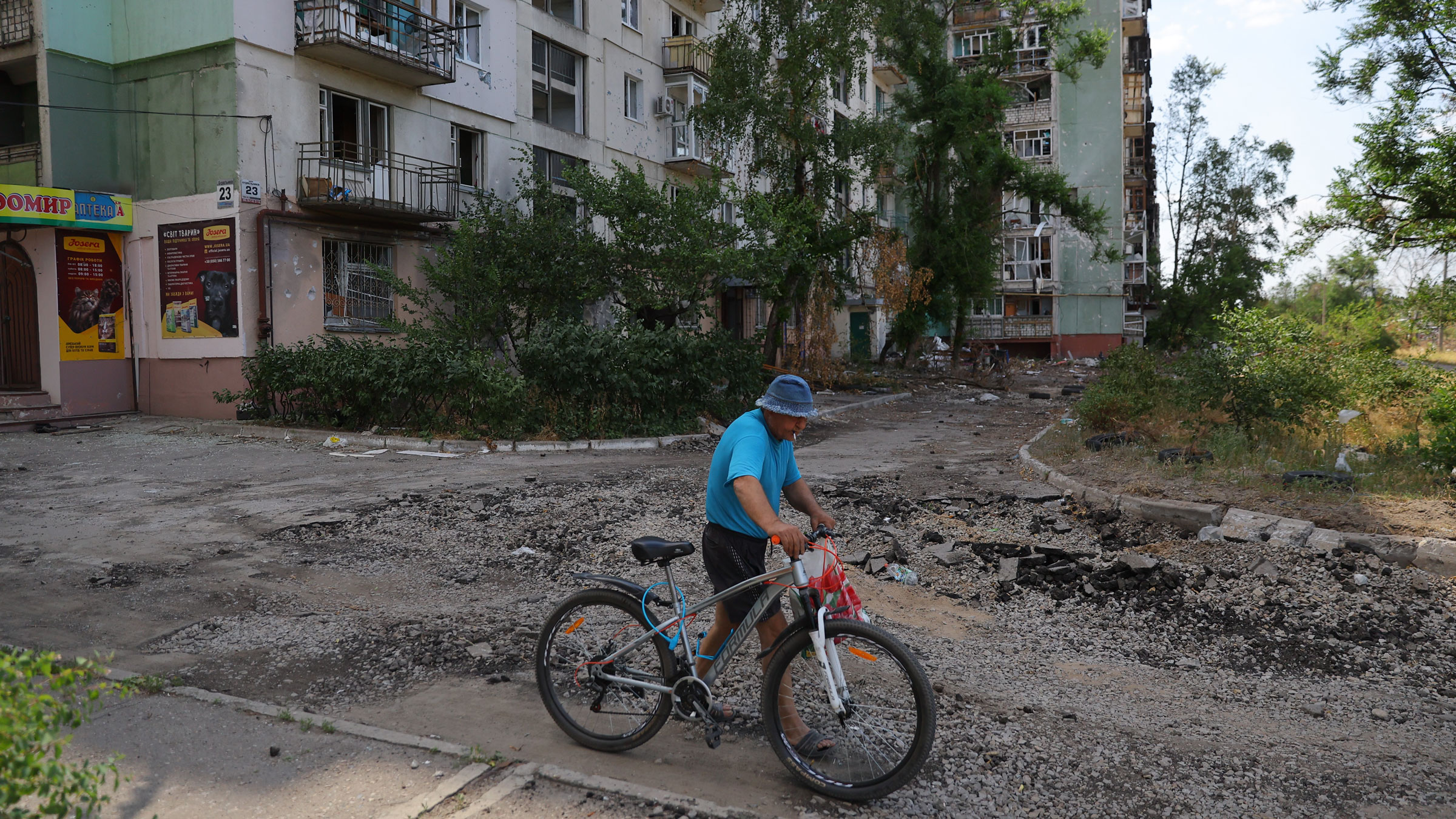 A resident walks a bike past a building in Severodonetsk, Ukraine, on July 1.