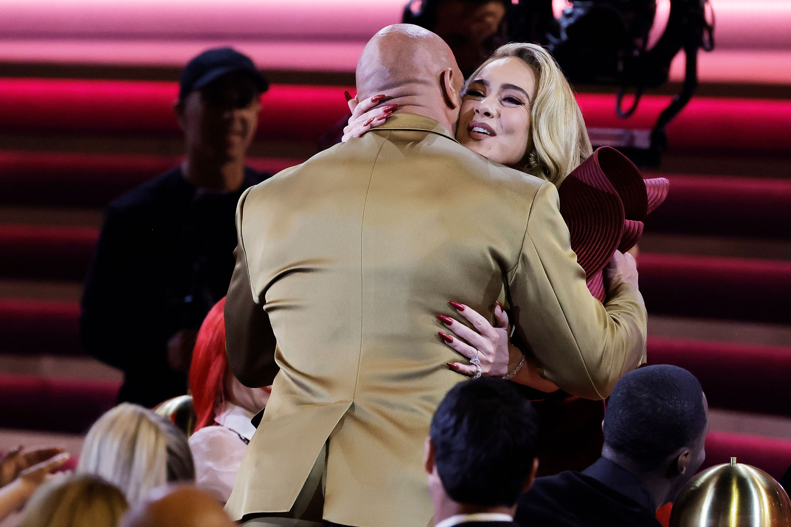 Adele hugs Dwayne "The Rock" Johnson on Sunday in Los Angeles. 