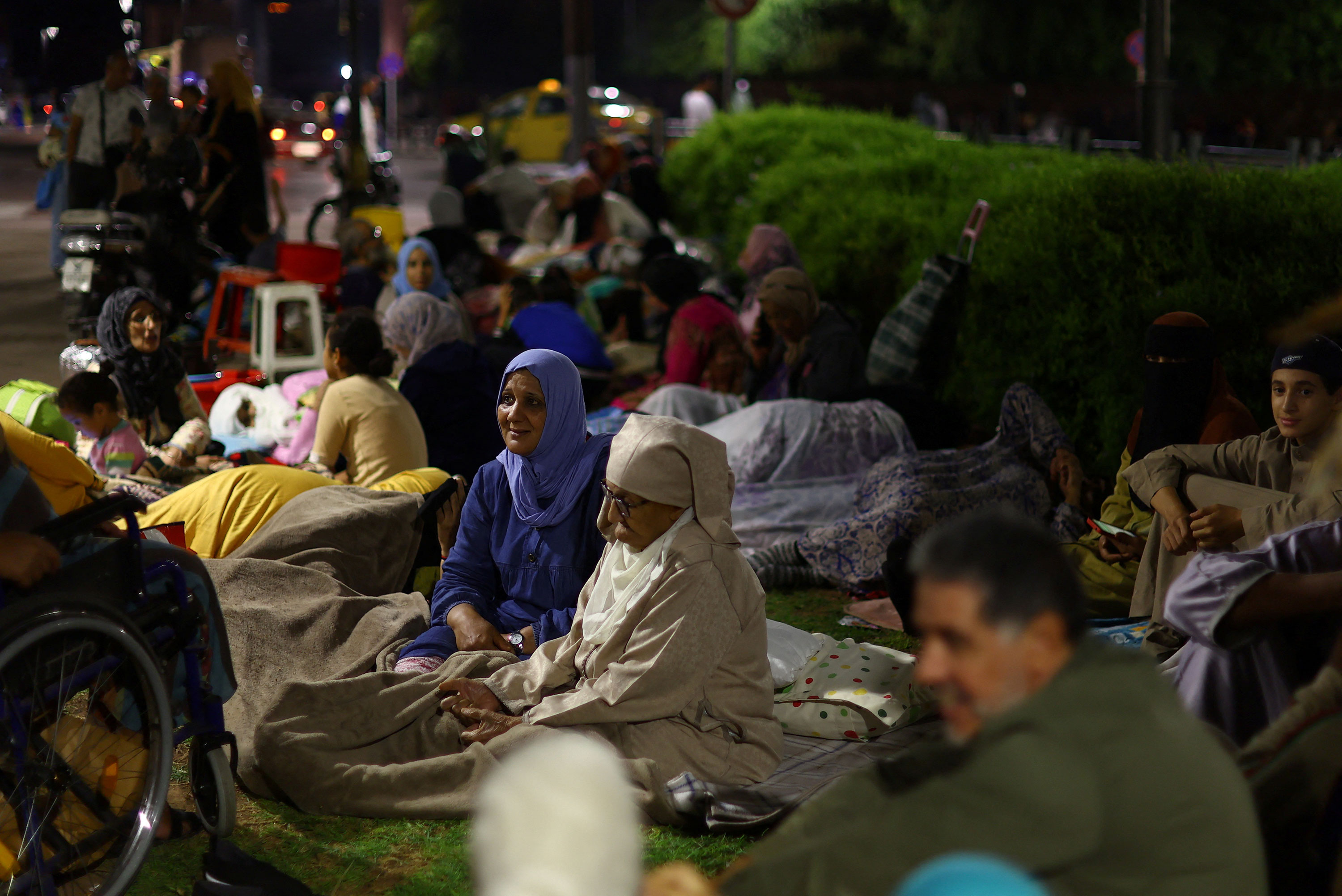 People rest outside in central Marrakech, Morocco, on Saturday. 