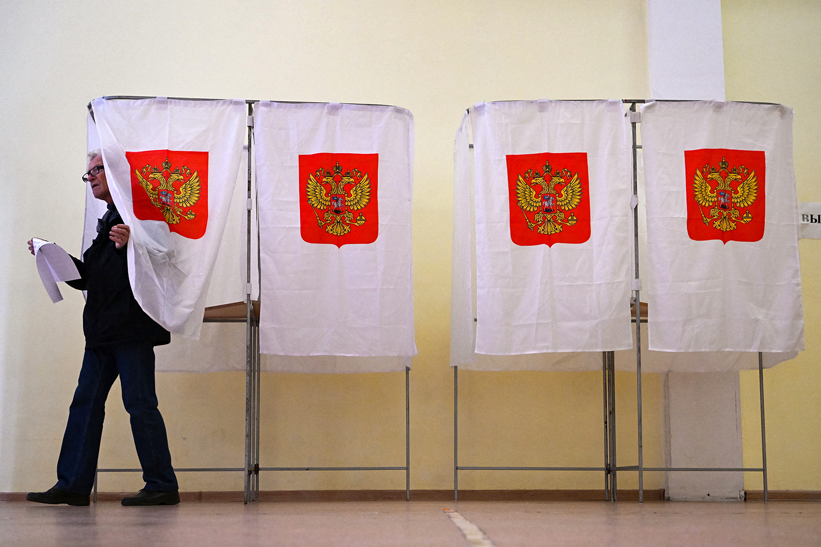 A man leaves a voting booth during the Moscow municipal deputies elections at a polling station in Moscow on September 9.