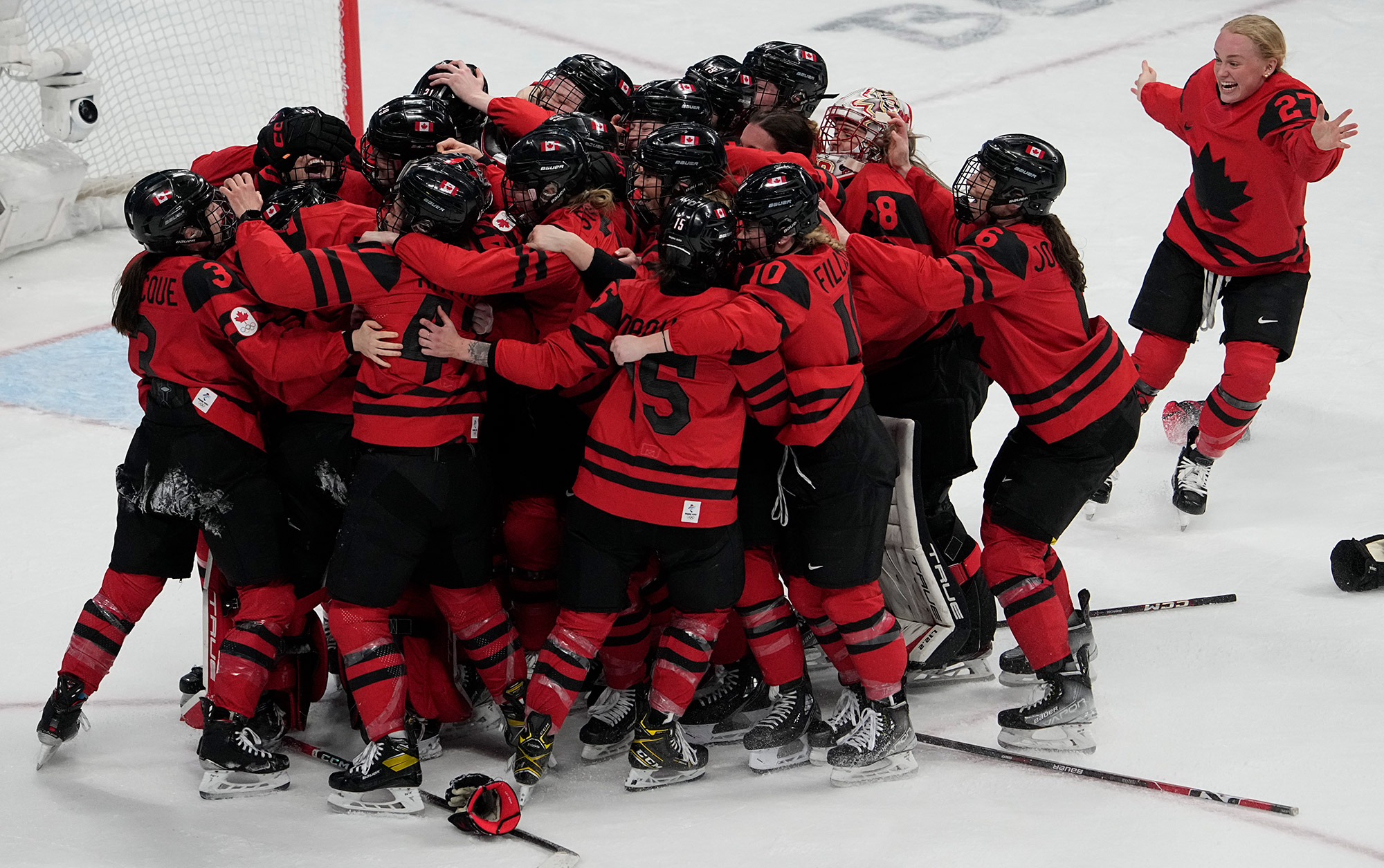 The Canadian women's hockey team celebrates after winning the gold-medal game on Thursday.
