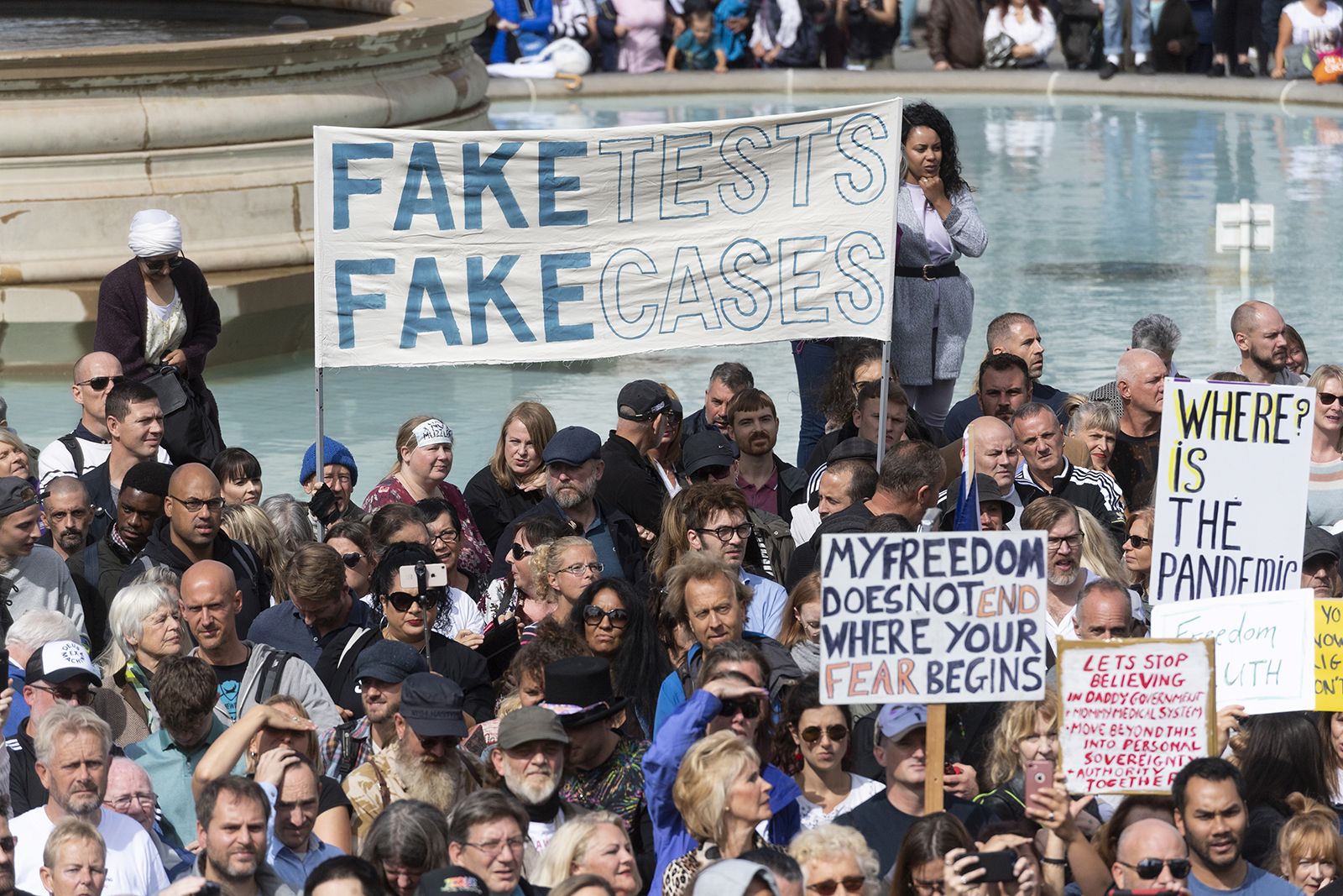 Protesters holding placards as they take part in a demonstration in Trafalgar Square organized by the group Stand Up X in London, on August 29, 2020. 