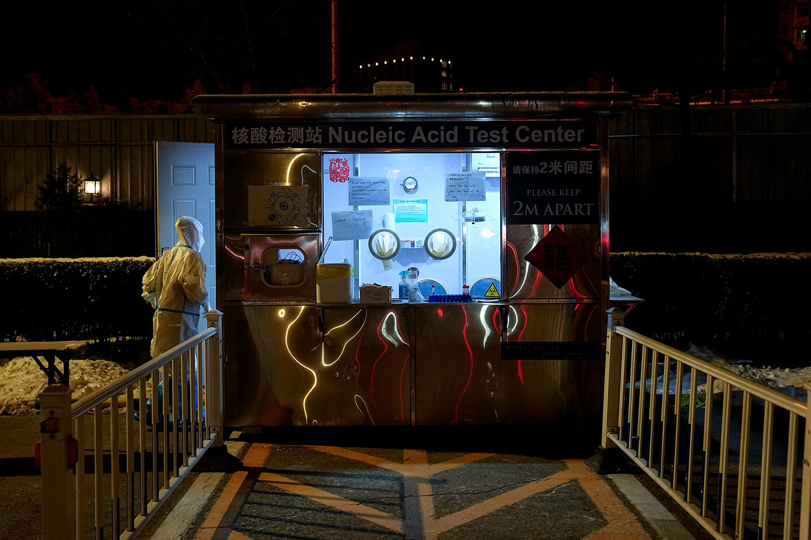 A medical worker walks into a Covid-19 testing booth outside of the Shangri-La Hotel on February 16.