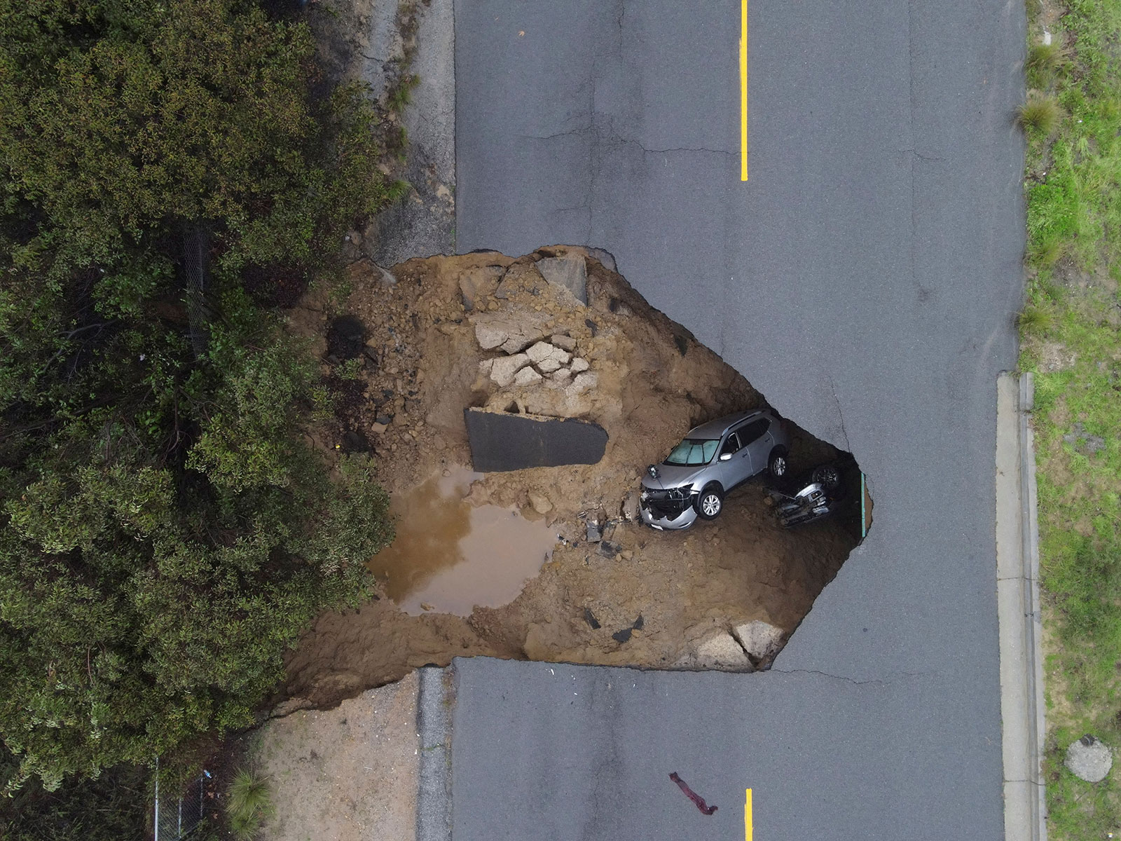 Two vehicles are seen in a sinkhole in Chatsworth, California, on January 10.