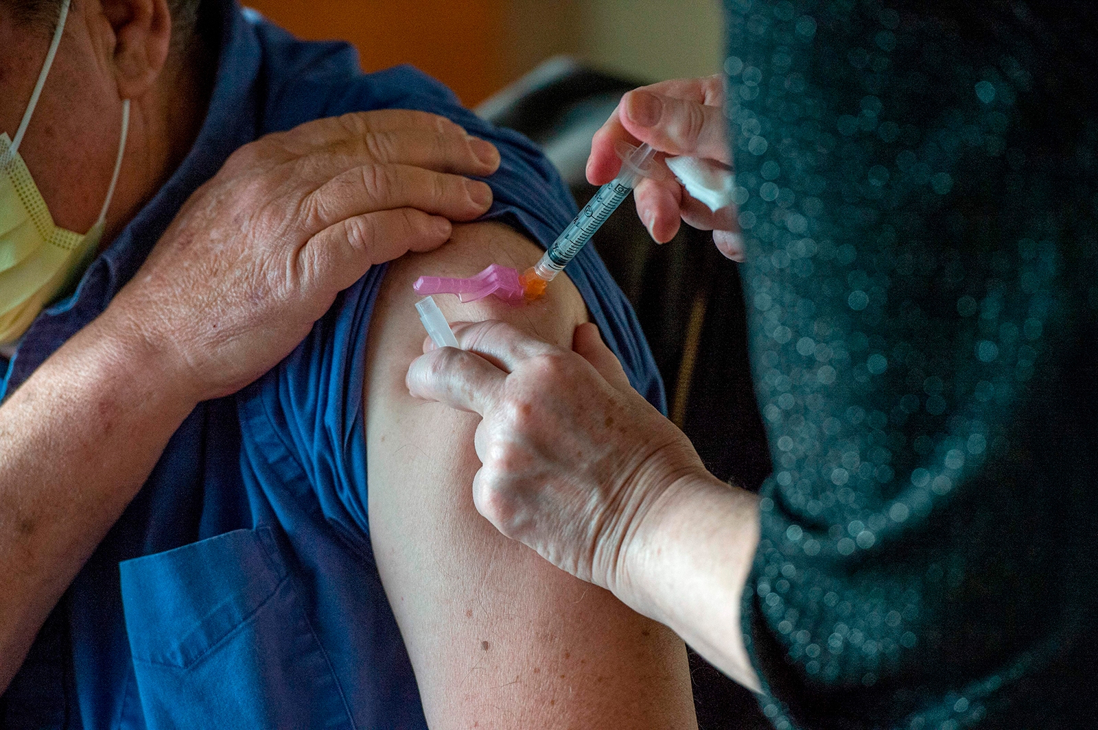 A person receives the Moderna Covid-19 vaccine at the East Boston Neighborhood Health Center (EBNHC) in Boston, Massachusetts, on December 24, 2020.