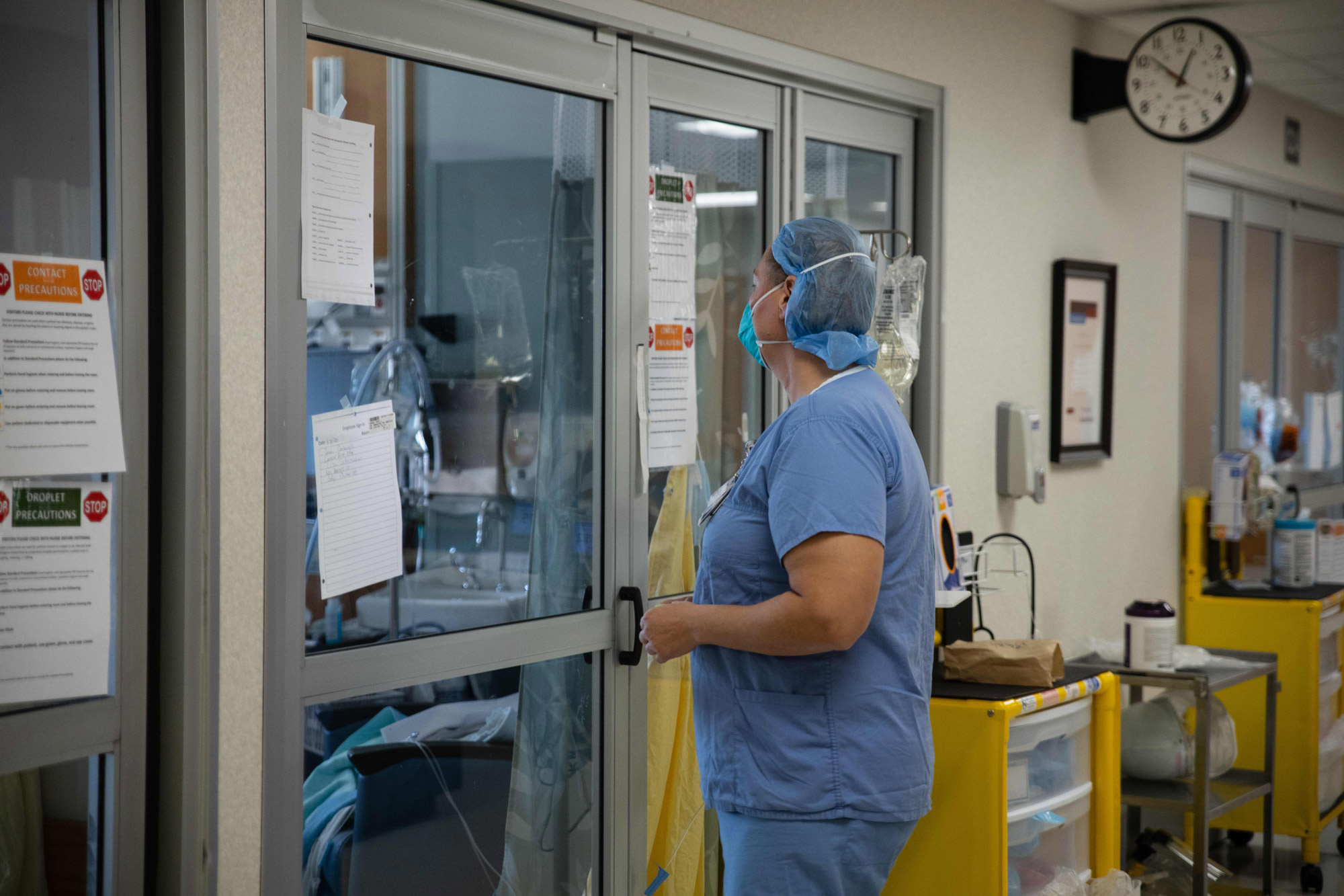 A healthcare professional prepares to enter a Covid-19 patient's room in the ICU at Van Wert County Hospital in Van Wert, Ohio on November 20.