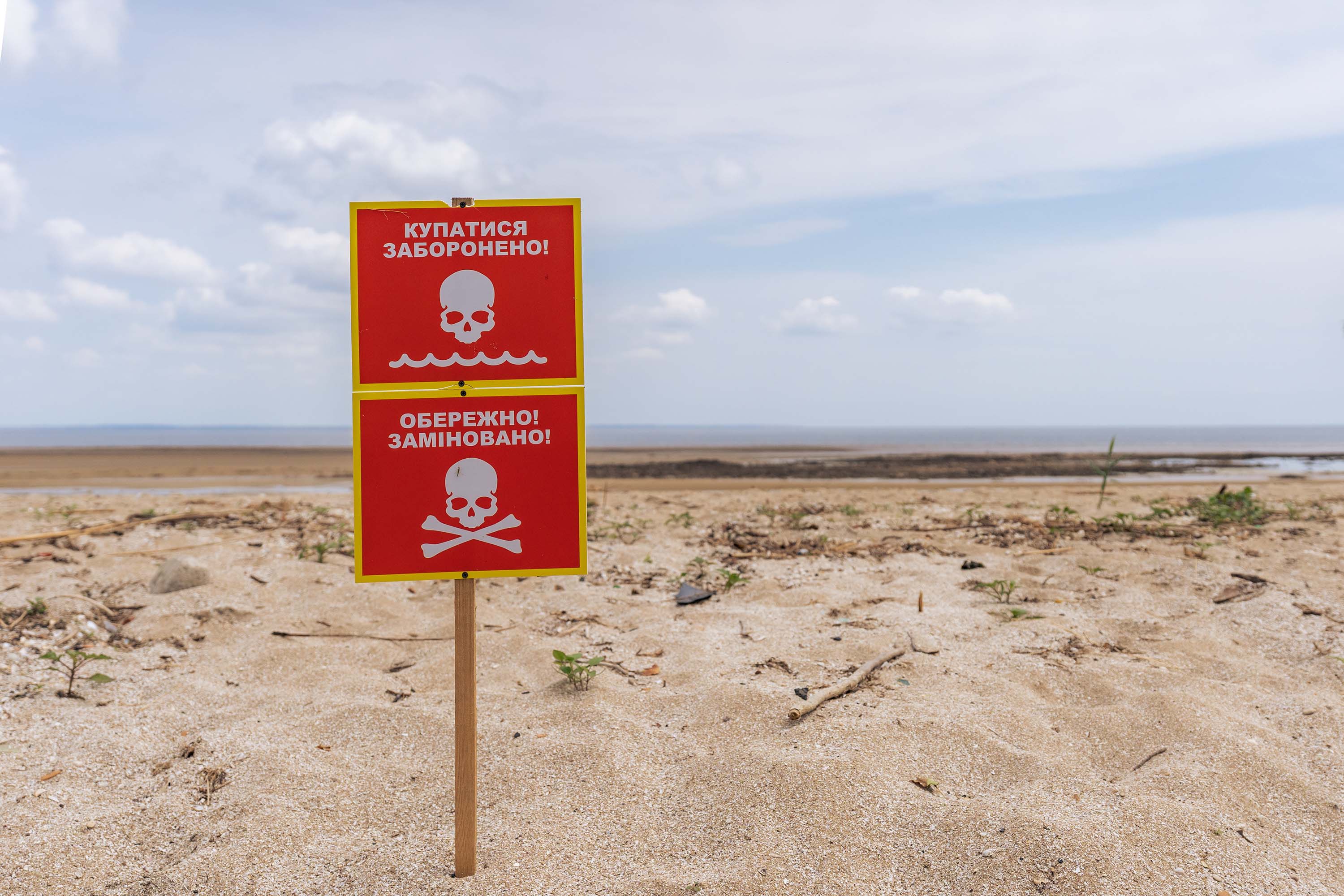 A sign warns of mines along the shore of Kakhovka Reservoir, on June 13, in Novovorontsovka, Ukraine. 