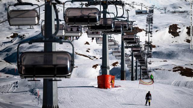 A professional athlete skis by chairlifts on Plan Maison ski run in the alpine ski resort of Breuil-Cervinia, northwestern Italy, on November 25. 