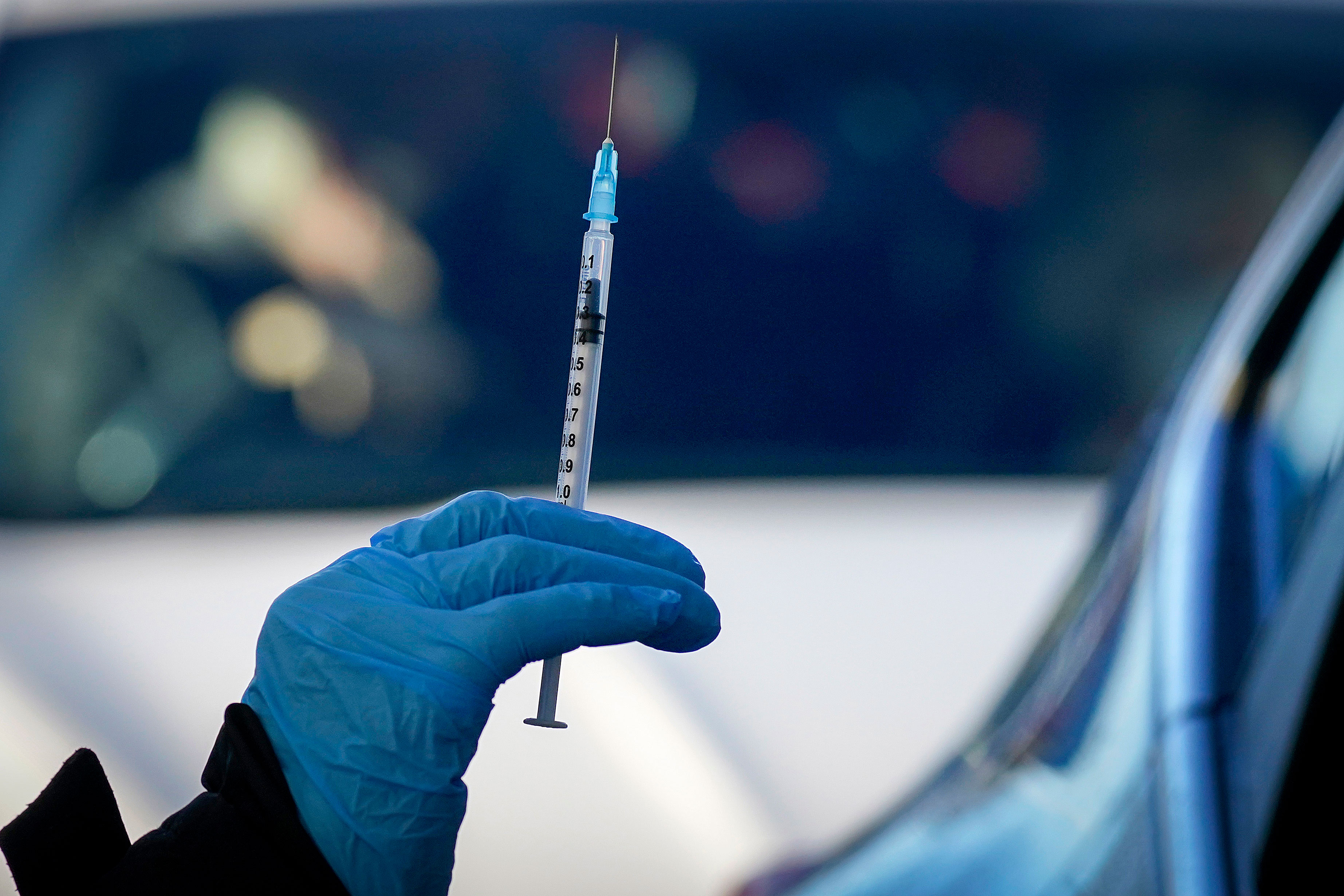 A nurse in Manchester, England, prepares to administer the Pfizer/BioNTech Covid-19 vaccine at a drive-thru vaccination center on December 17.