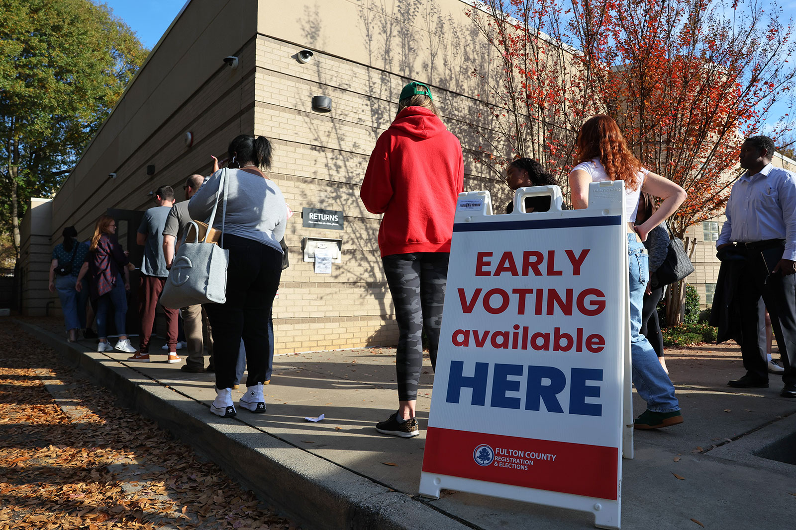 People wait in line for early voting on November 4, in Atlanta 