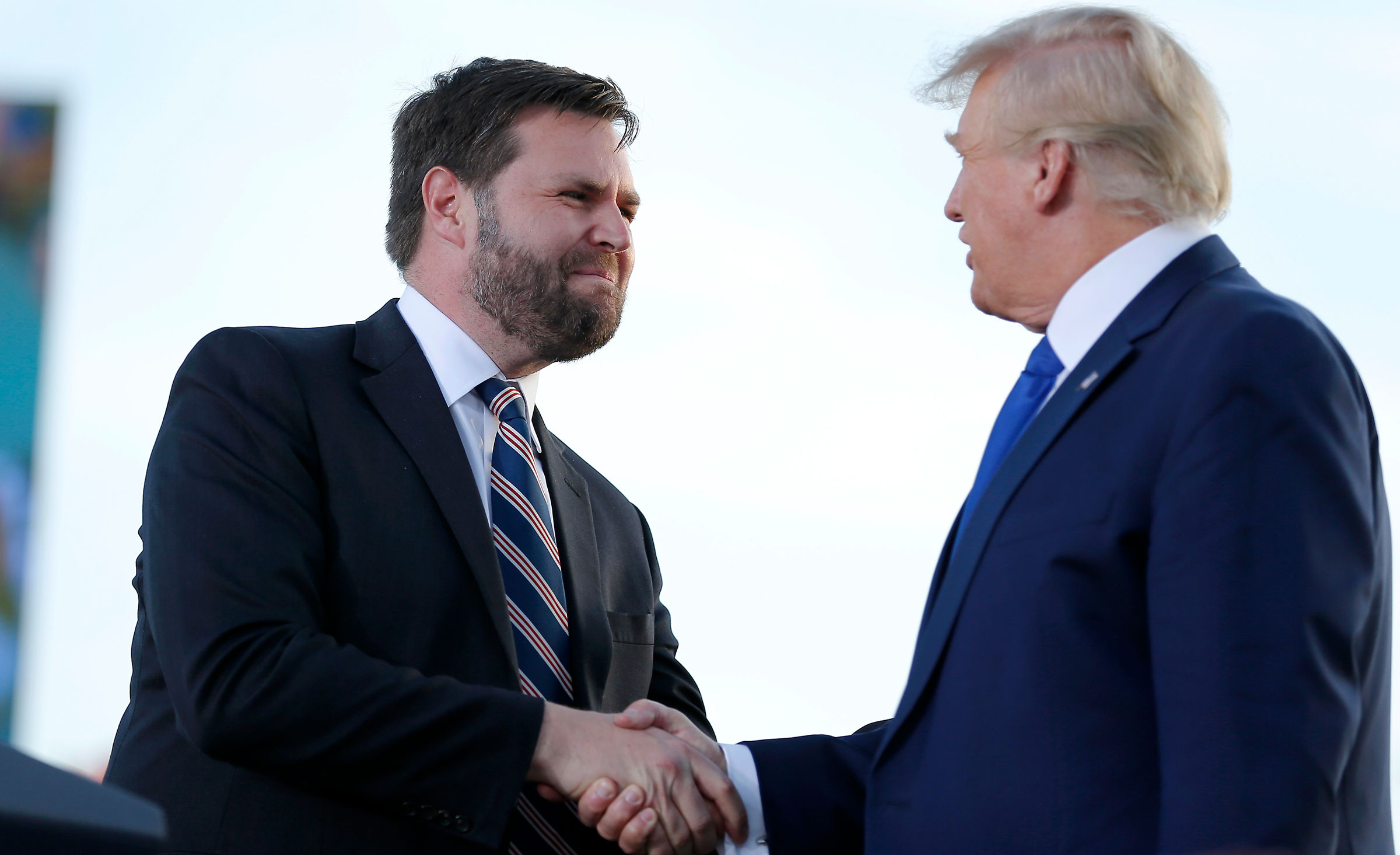 Senate candidate J.D. Vance, left, greets former President Donald Trump at a rally in Delaware, Ohio, last month.