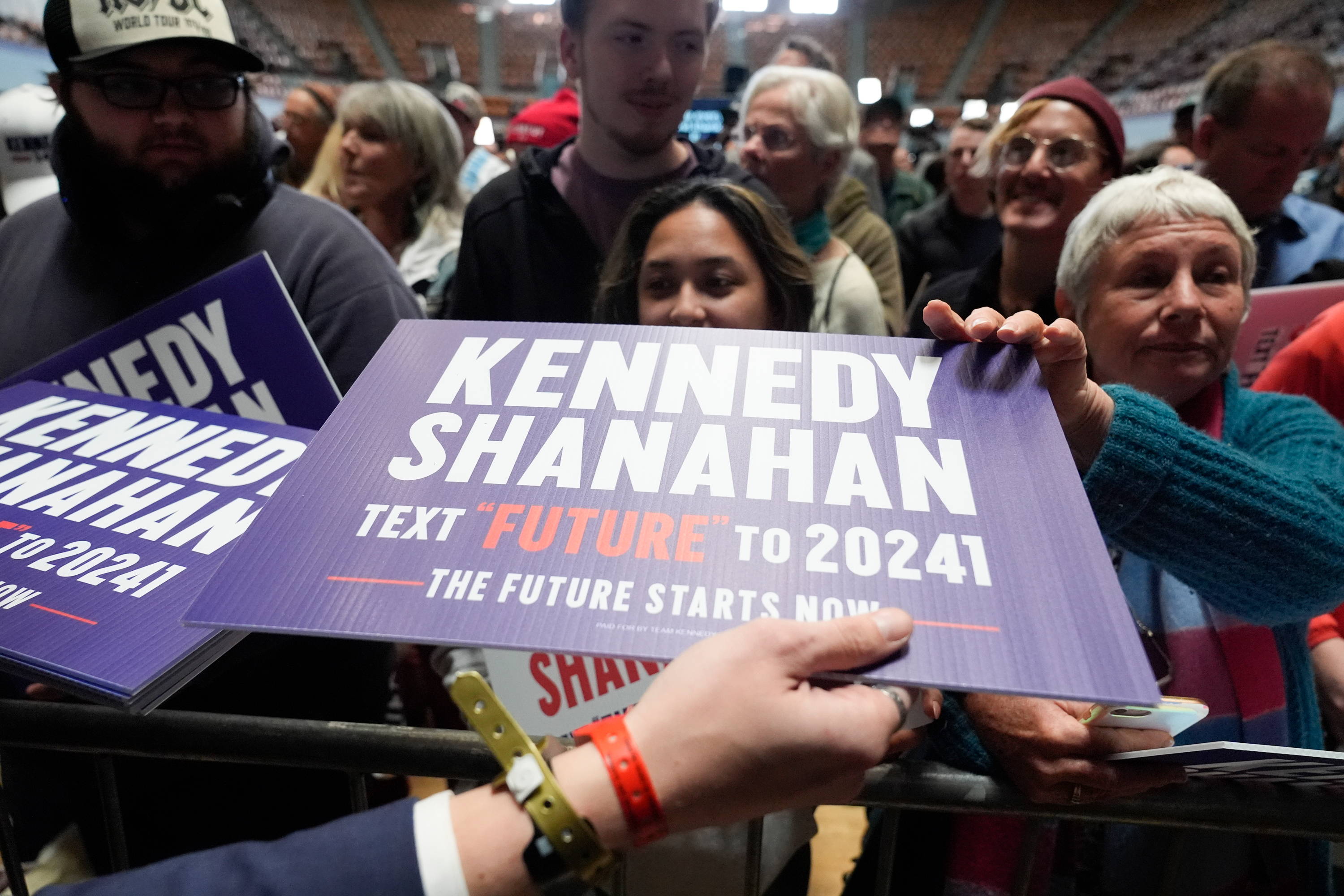 Supporters are handed signs during a campaign event for Presidential candidate Robert F. Kennedy Jr. in Oakland, California on March 26.