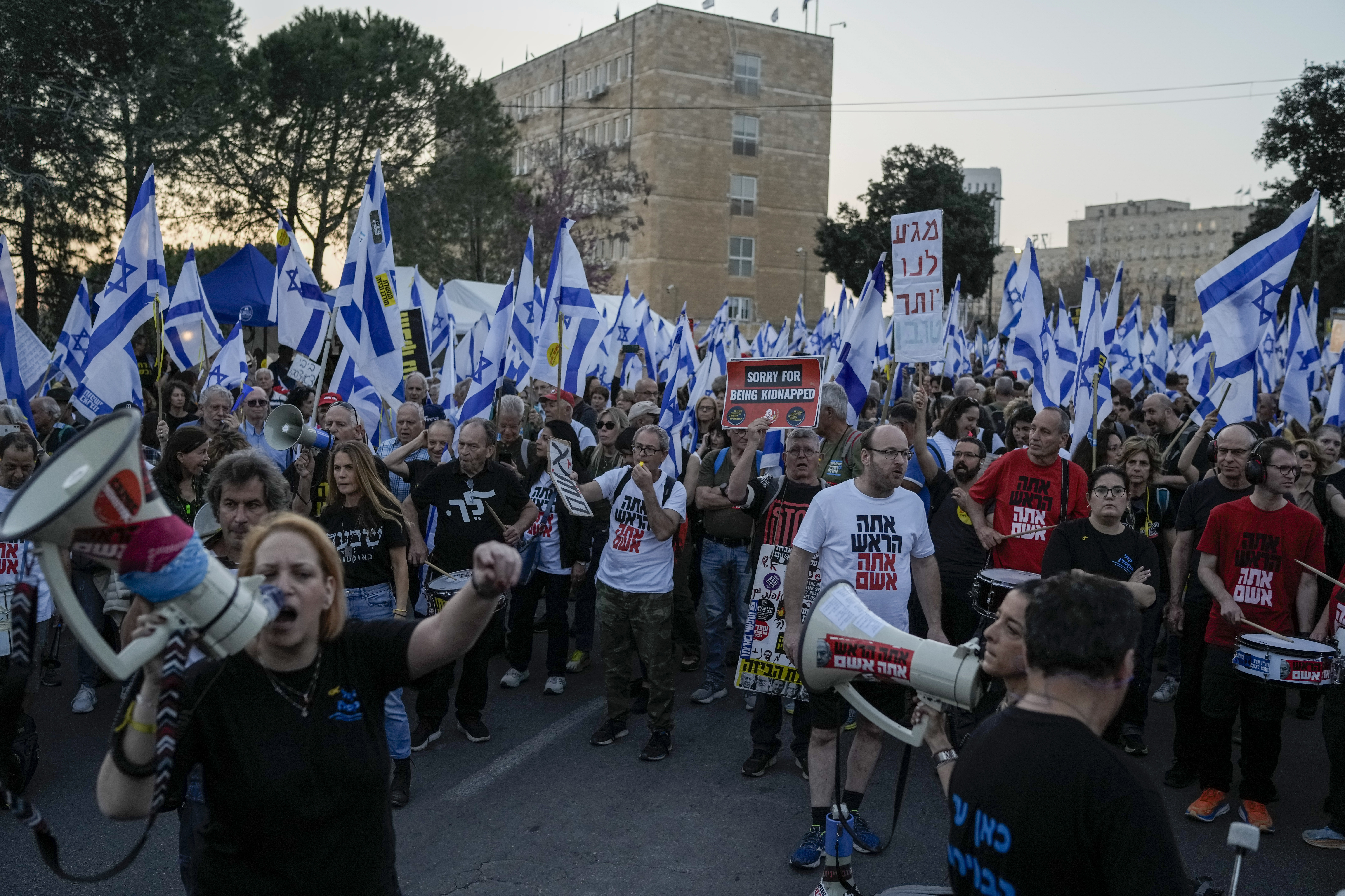 People take part in a protest against Israeli Prime Minister Benjamin Netanyahu's government, and call for the release of hostages held in Gaza, outside the Knesset, Israel's parliament, in Jerusalem on March 31. 