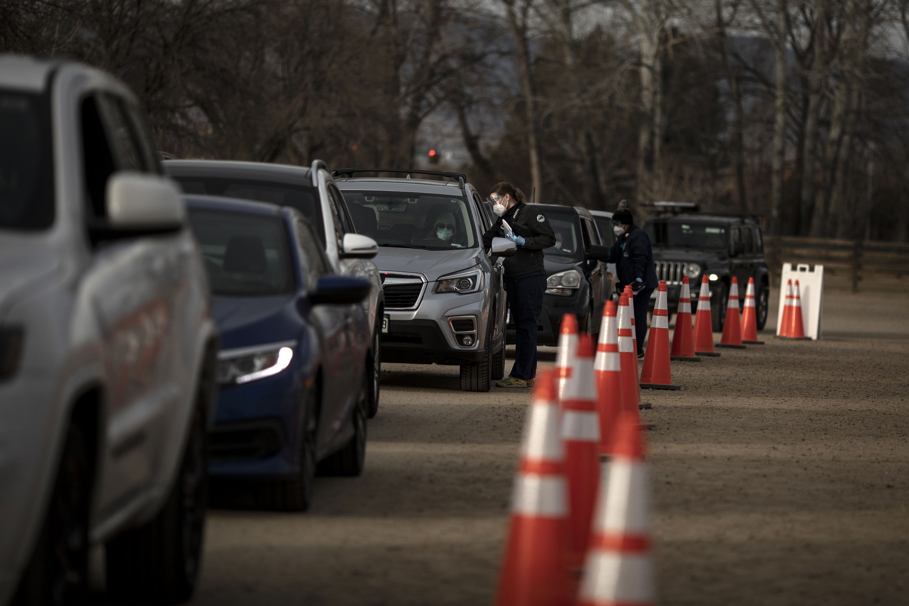 Drivers line up to receive Covid-19 swab tests at a testing site in Longmont, Colorado, on December 14.
