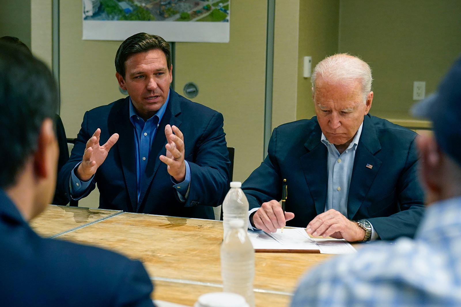 President Joe Biden listens as Florida Gov. Ron DeSantis speaks during a briefing in Miami Beach, Florida, on Thursday, July 1.