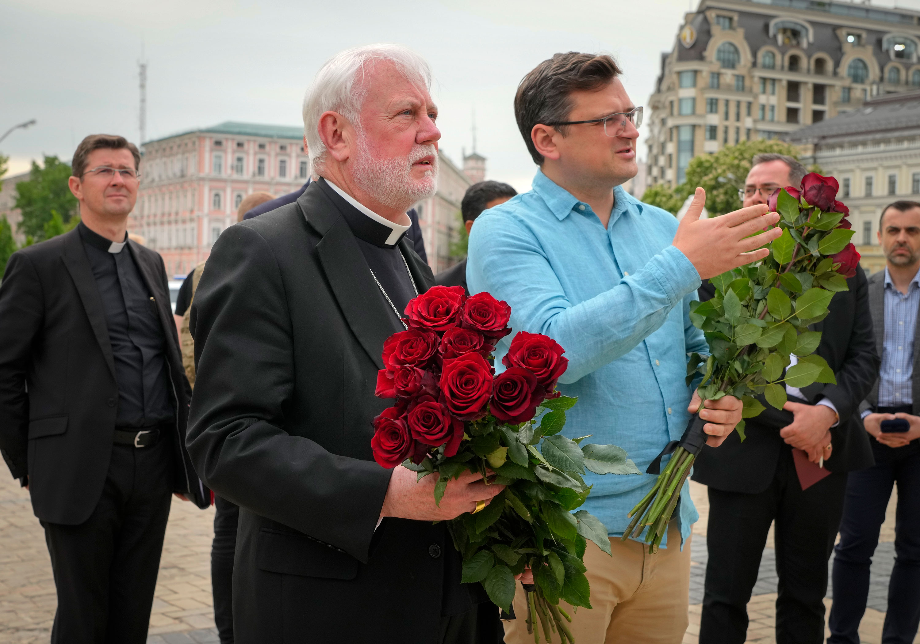 Archbishop Paul, second left, and Ukrainian Foreign Minister Dmytro Kuleba lay flowers at the Memorial Wall of Fallen Defenders of Ukraine in Kyiv on Friday.