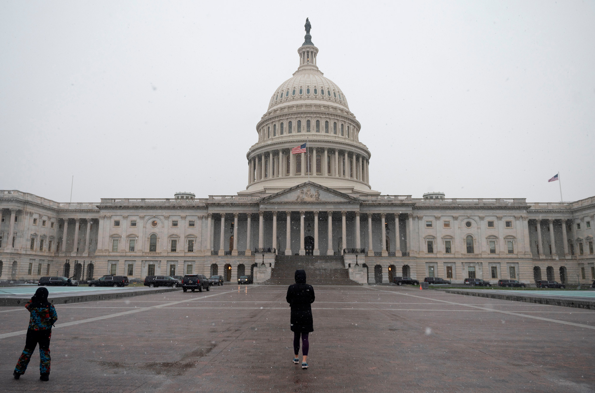 People walk past the US Capitol in Washington, DC, on December 16.