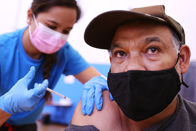 A nurse administers a vaccine dose to a person at a vaccination clinic at Providence Wilmington Wellness and Activity Center on July 29, 2021 in Wilmington, California. 