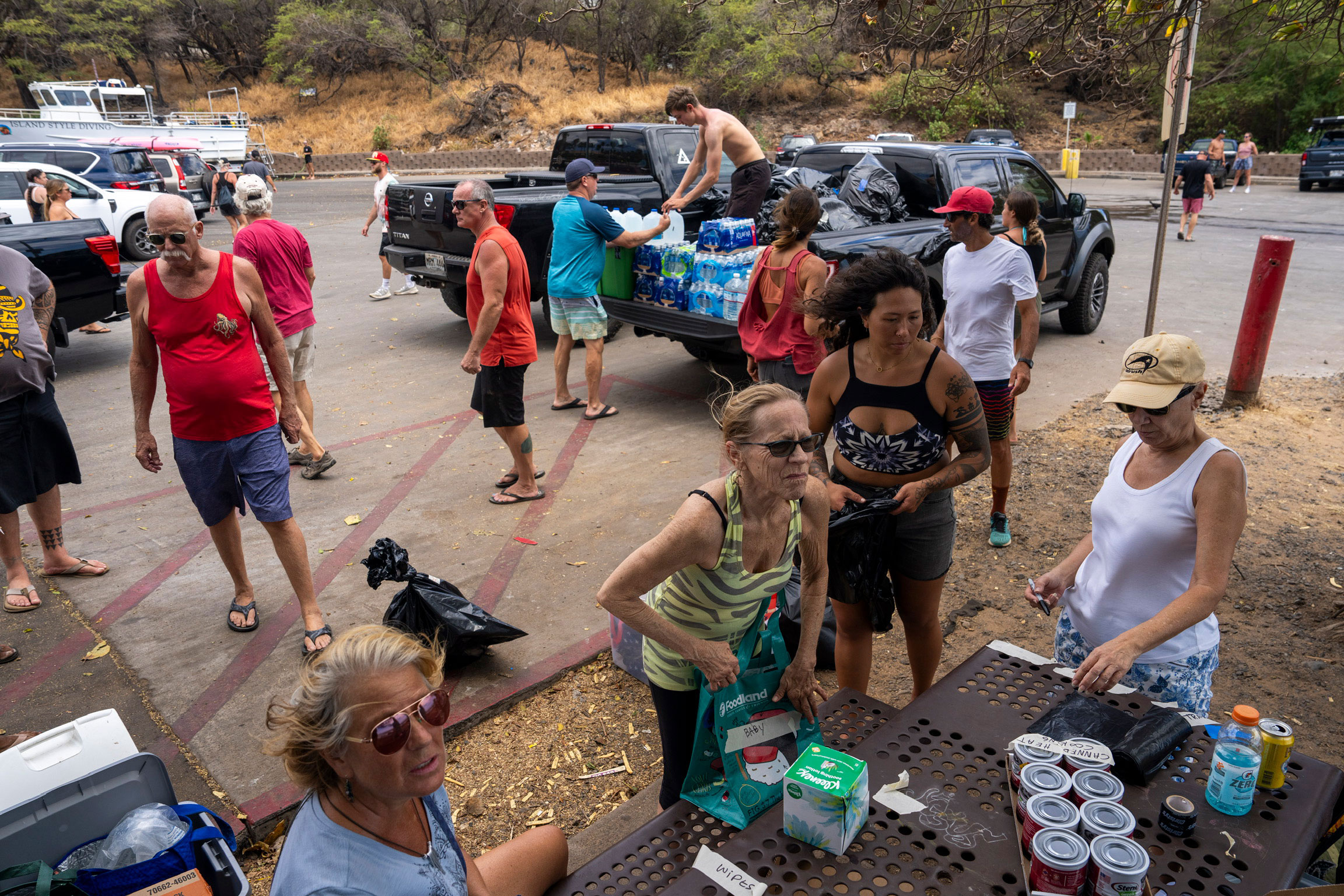 Volunteers unload supplies from trucks before loading them onto boats for people in need at Kihei Ramp on Maui on Saturday. 