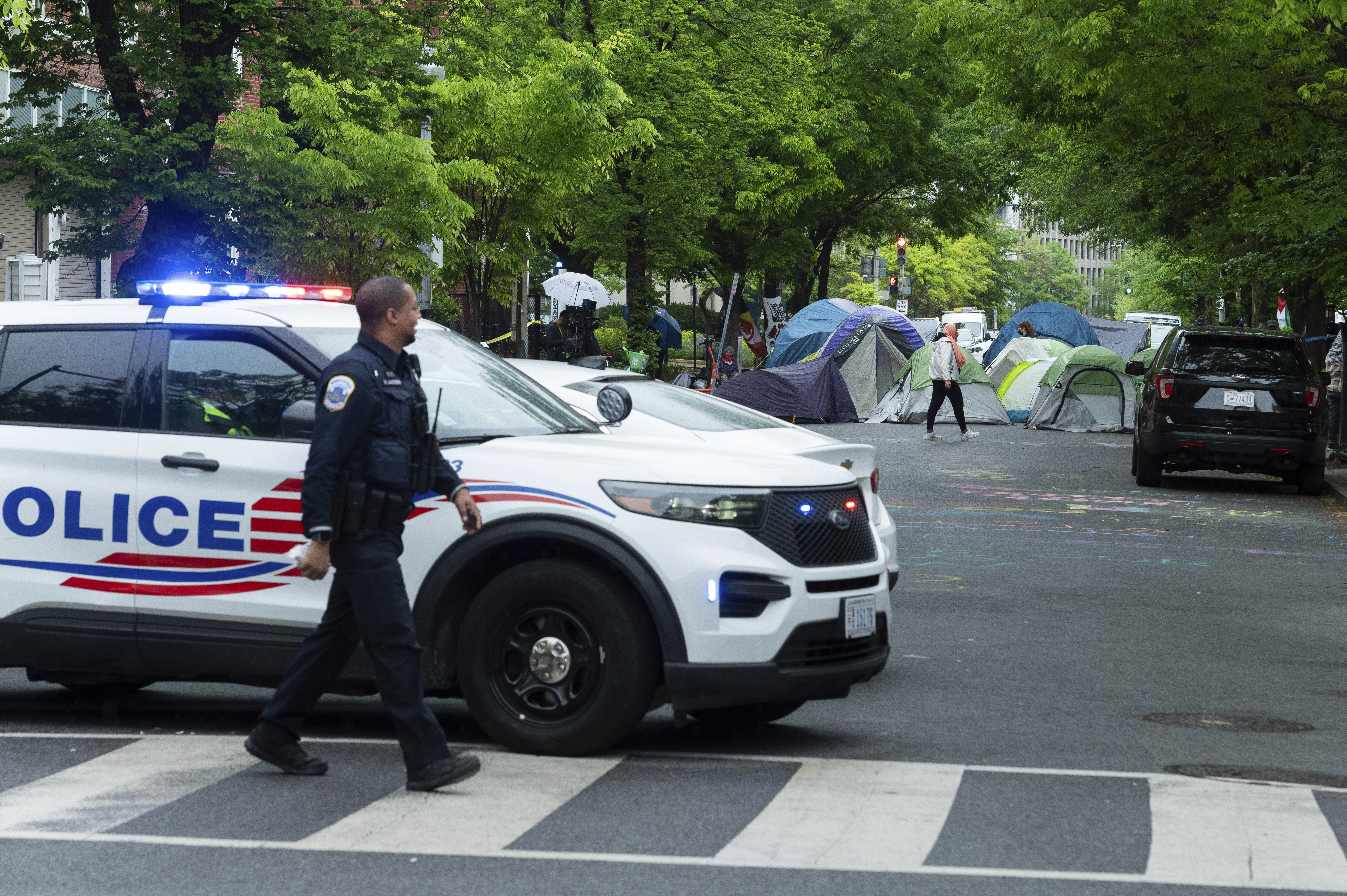 Police close the street near people protesting at the George Washington University in Washington, DC, on April 27.