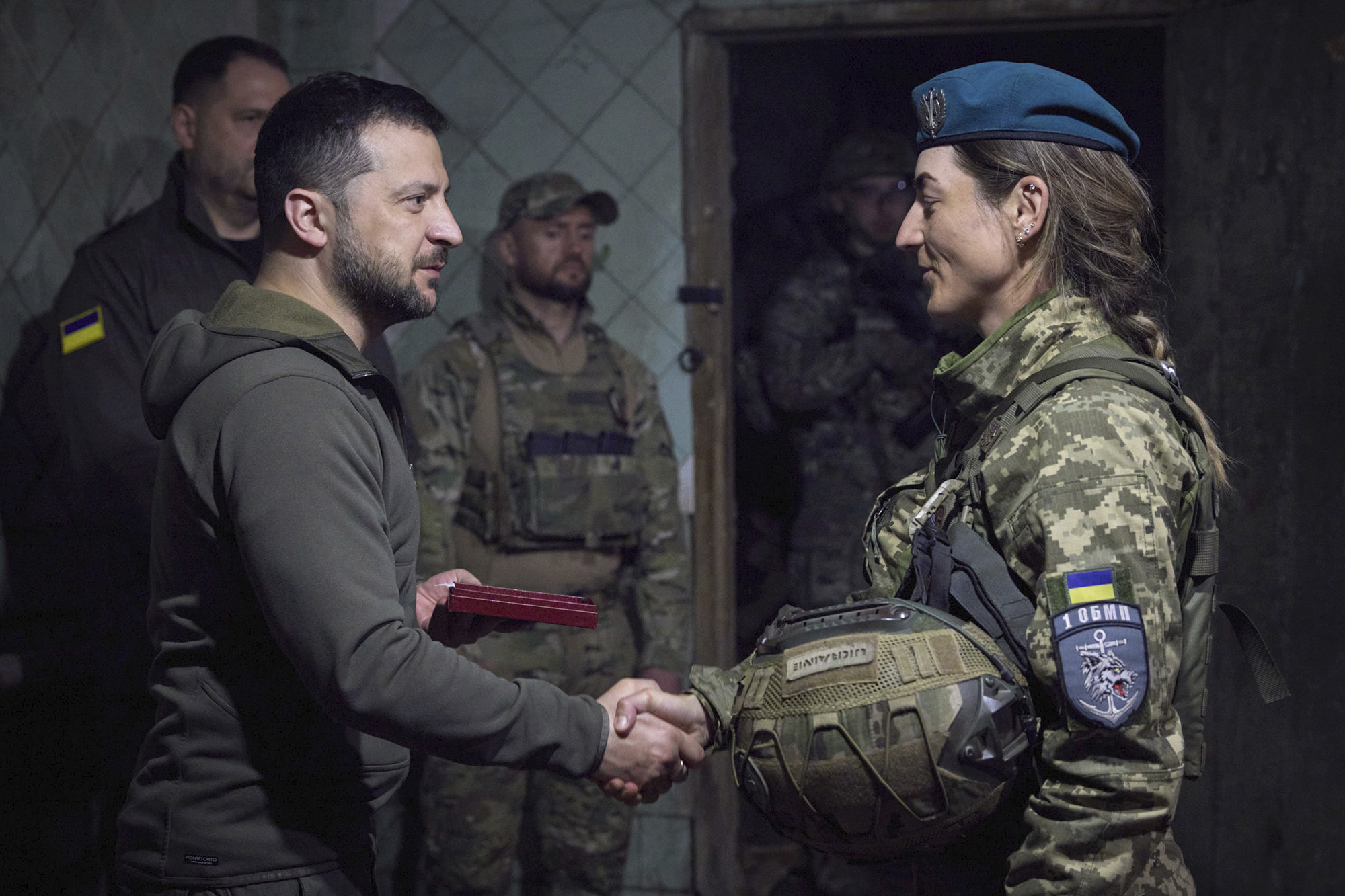 Ukrainian president Volodymyr Zelenskyy shakes hands with a service woman during an awarding ceremony as he visits the Donetsk region, Ukraine, on May 23.