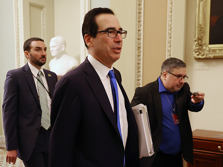 Treasury Secretary Steven Mnuchin moves from one meeting to another as he continues negotiations on a $2 trillion economic stimulus in response to the coronavirus pandemic on Tuesday, March 24.