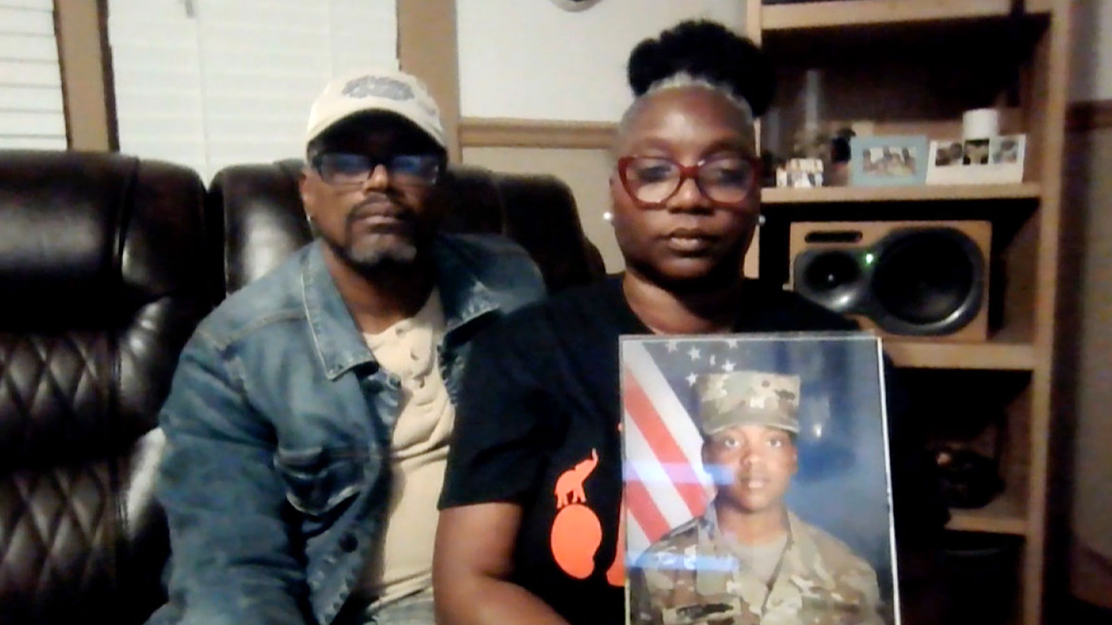  Shawn Sanders and Oneida Oliver-Sanders hold a photo of their daughter, Army Specialist Kennedy Sanders.