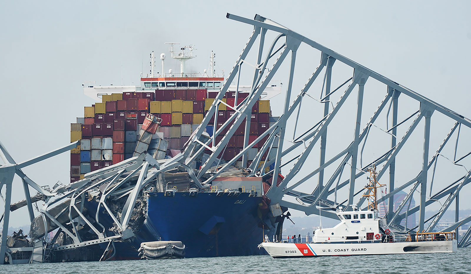 A Coast Guard cutter passes where the cargo ship stuck the structure of the Francis Scott Key Bridge after the ship hit the bridge on Tuesday, March 26.