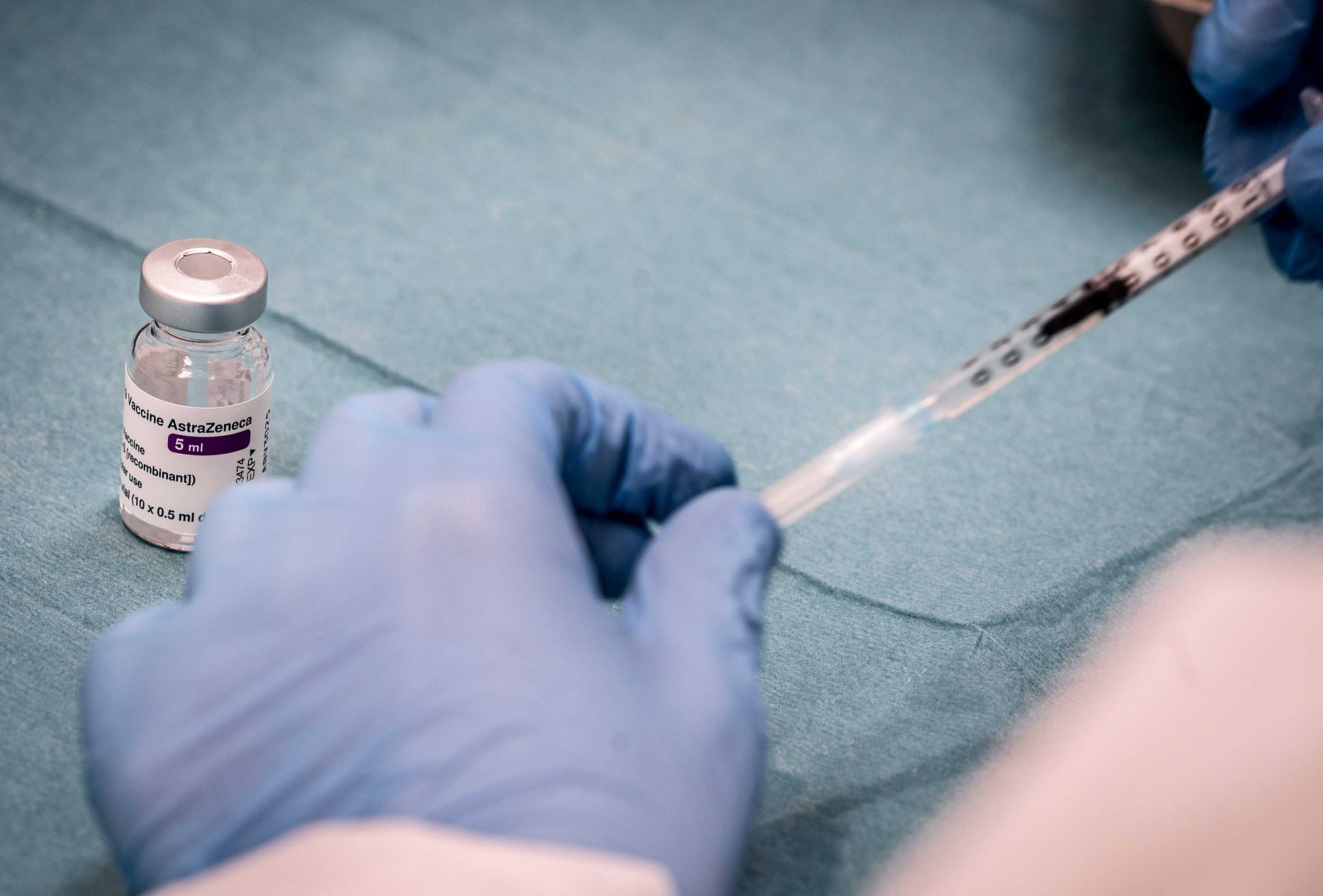 A medical worker prepares a syringe with the AstraZeneca vaccine at a vaccine center in Copenhagen, Denmark, on February 11. 