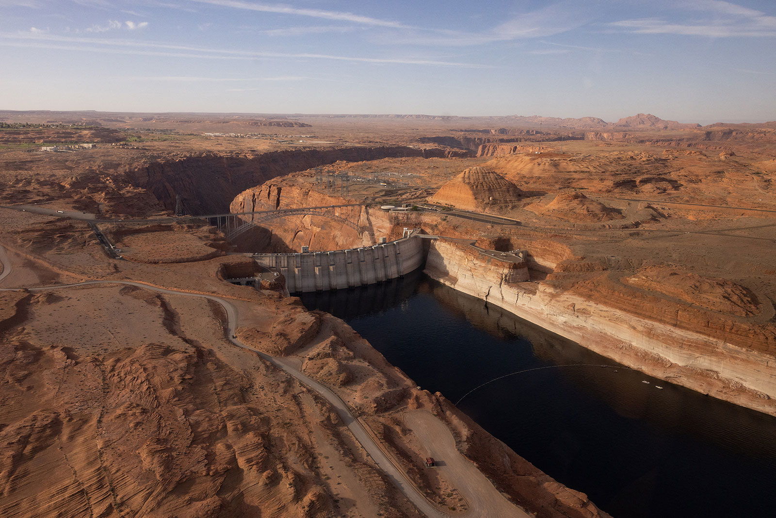 An aerial view of Lake Powell and the Glen Canyon Dam in Page, Arizona. According to a statement, the Bureau of Reclamation says it will evaluate whether the dam can be modified to "allow water to be pumped or released from below currently identified critical and dead pool elevations.”