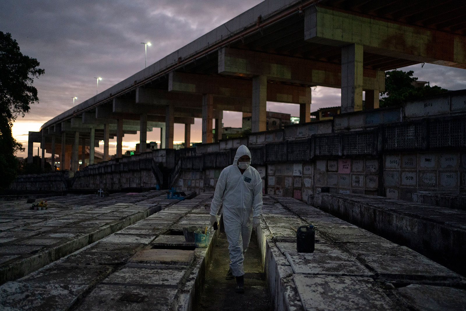 Cemetery worker Bruno Avelino walks through a graveyard in Rio de Janeiro, Brazil, on Friday, May 8.