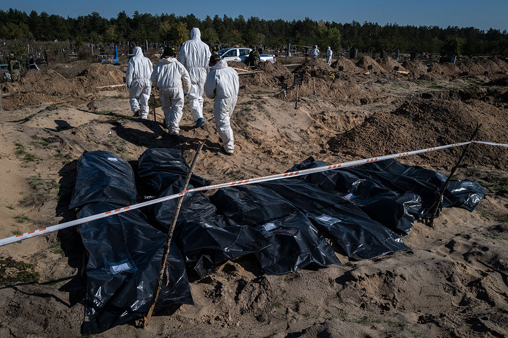 Authorities exhume the the bodies of slain civilians in Lyman, Ukraine on October 15. The bodies will be documented and reburied. 