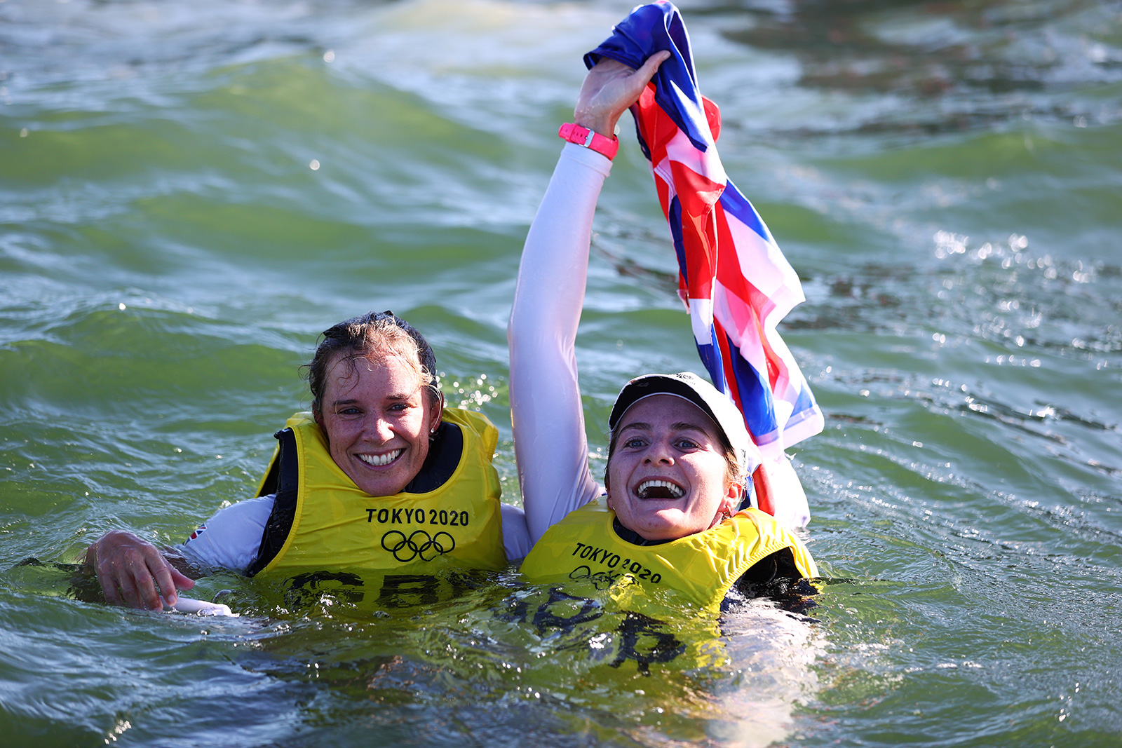 Hannah Mills, left, and Eilidh McIntyre of Team Great Britain celebrate in the water following the women’s 470 class sailing event on August 4.