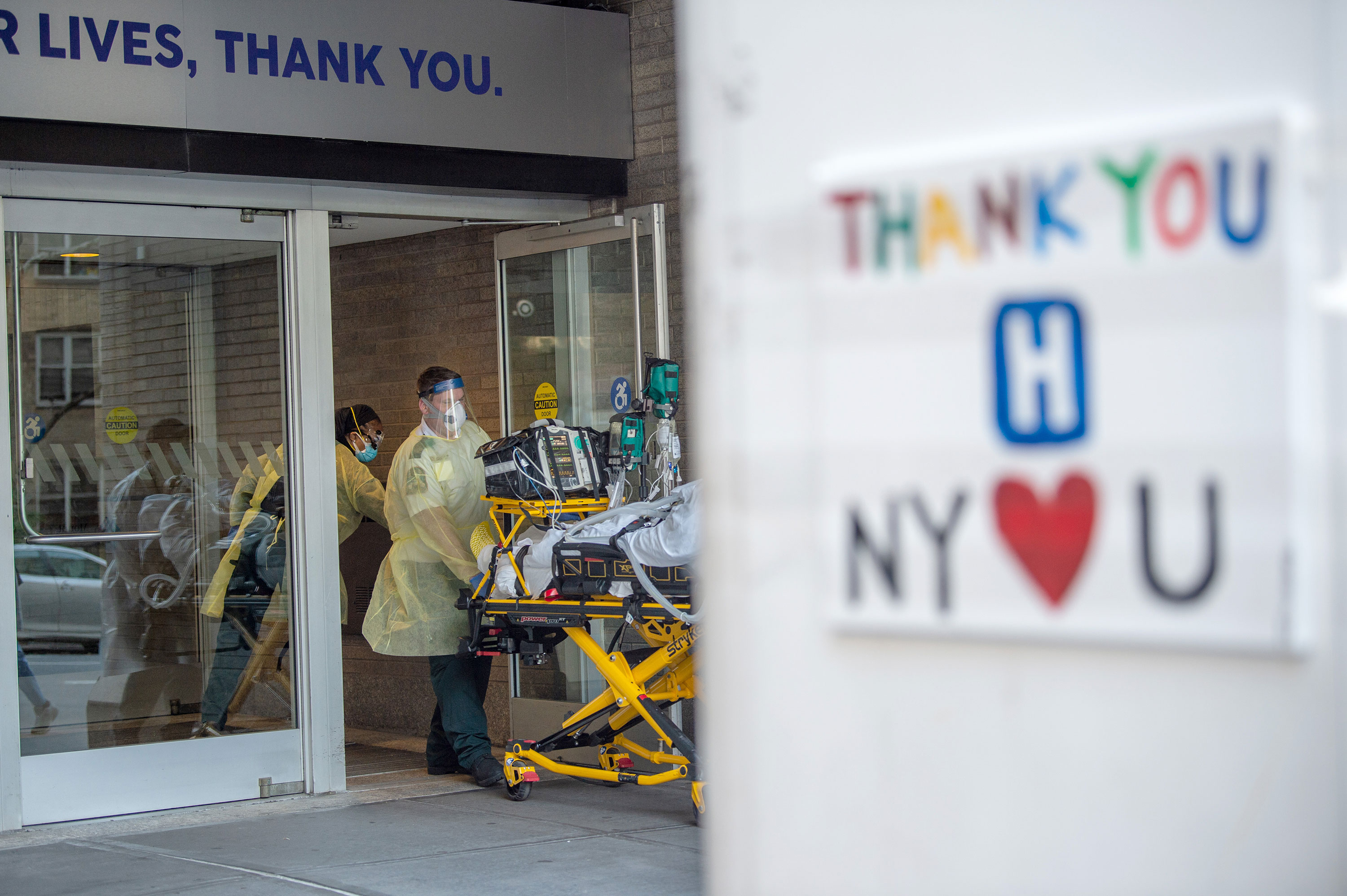 Medical workers roll a patient into Mount Sinai Hospital in New York on May 3.