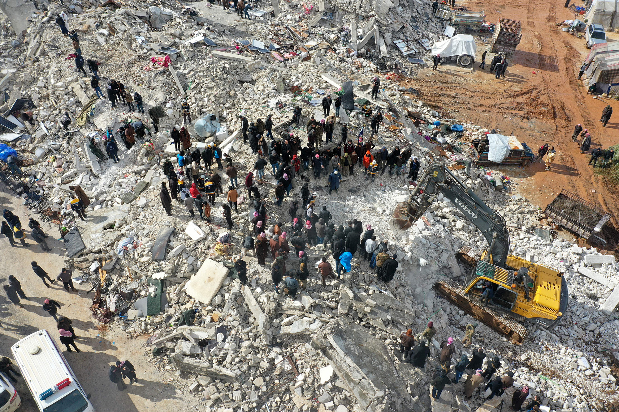 Residents searching for victims and survivors amidst the rubble of collapsed buildings following an earthquake in the village of Besnia, in Syria's Idlib province, on February 6.