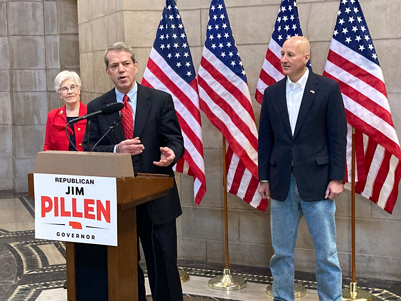 Jim Pillen, center, talks about his campaign after receiving an endorsement from Gov. Pete Ricketts, right, on January 18 at the state Capitol in Lincoln, Nebraska. 